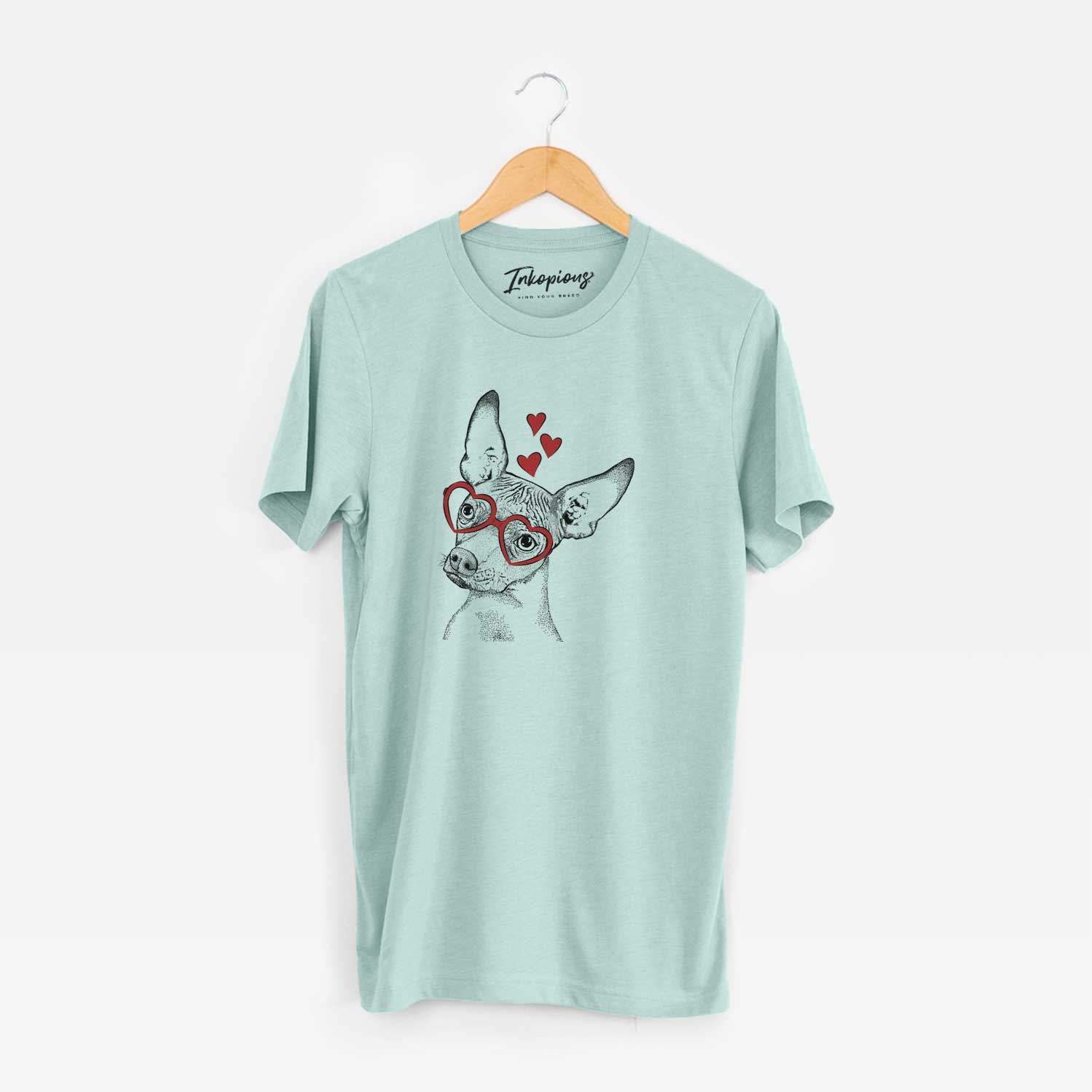 Hand-drawn sketch of Kahlo the Xoloitzcuintli wearing heart-shaped glasses on a Heather Sage Unisex crewneck