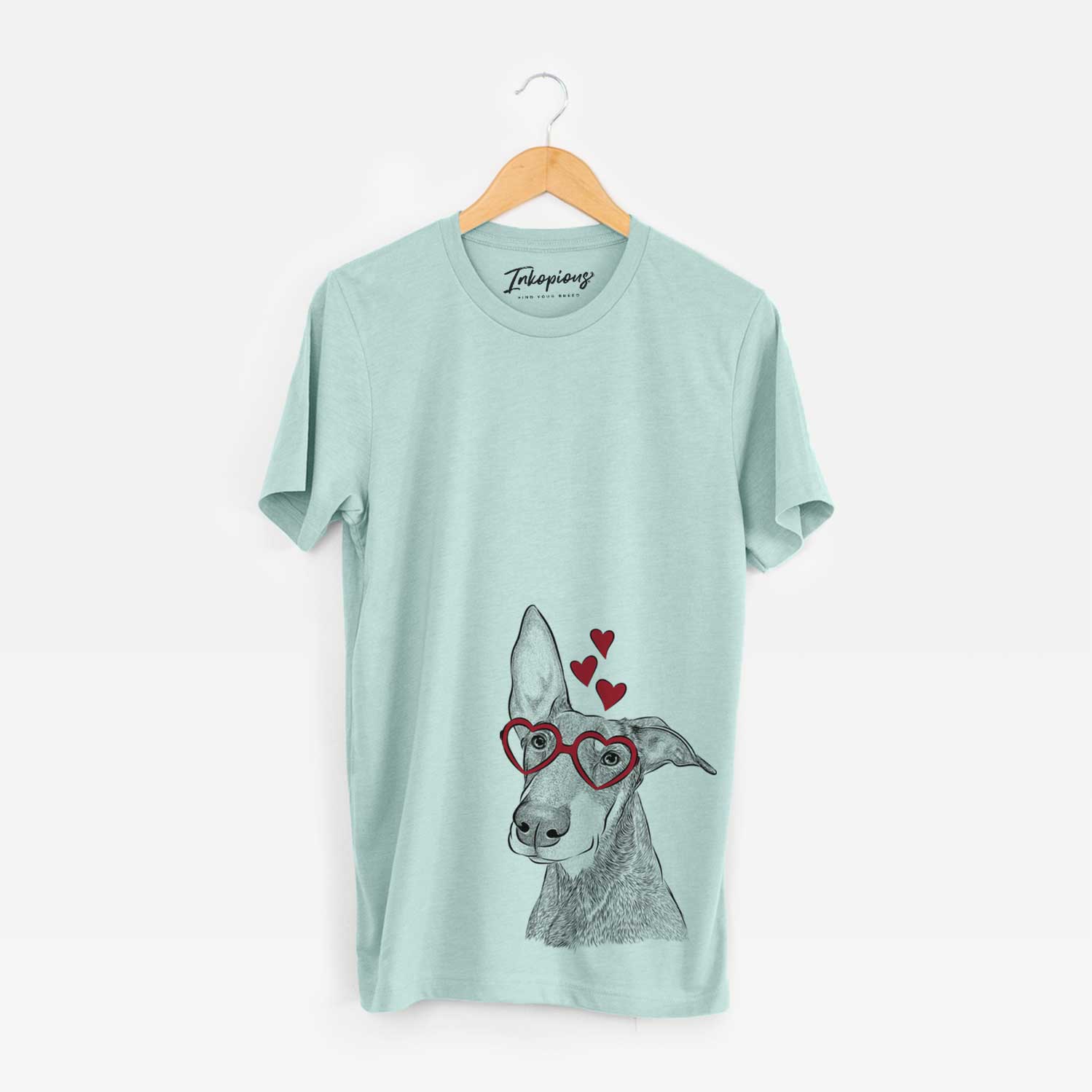 Hand-drawn sketch of Kain the Doberman Pinscher wearing heart-shaped glasses on a Heather Sage Bella Canvas Unisex Crewneck