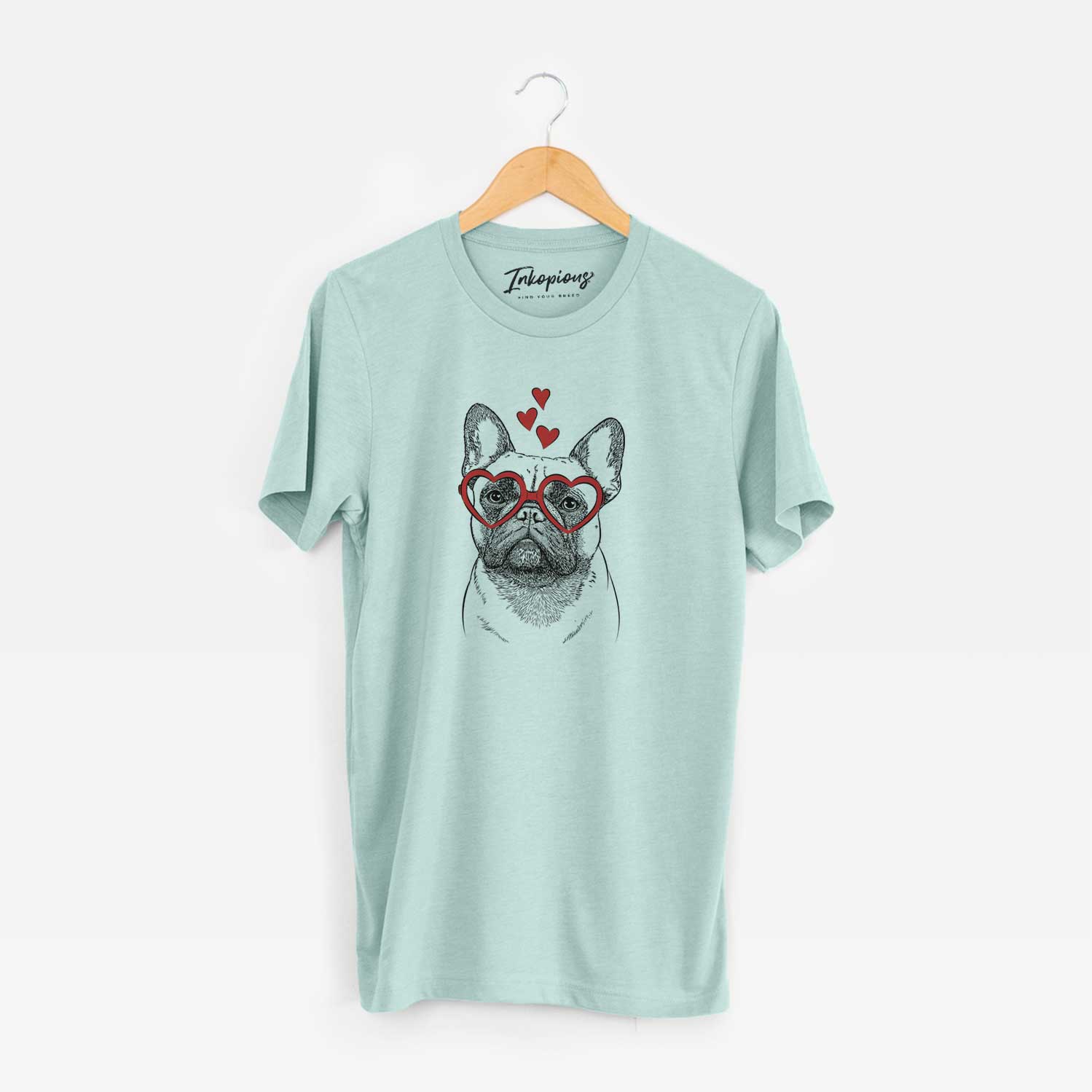 Hand-drawn sketch of Kingsleigh the French Bulldog wearing heart-shaped glasses on a Heather Sage Unisex crewneck