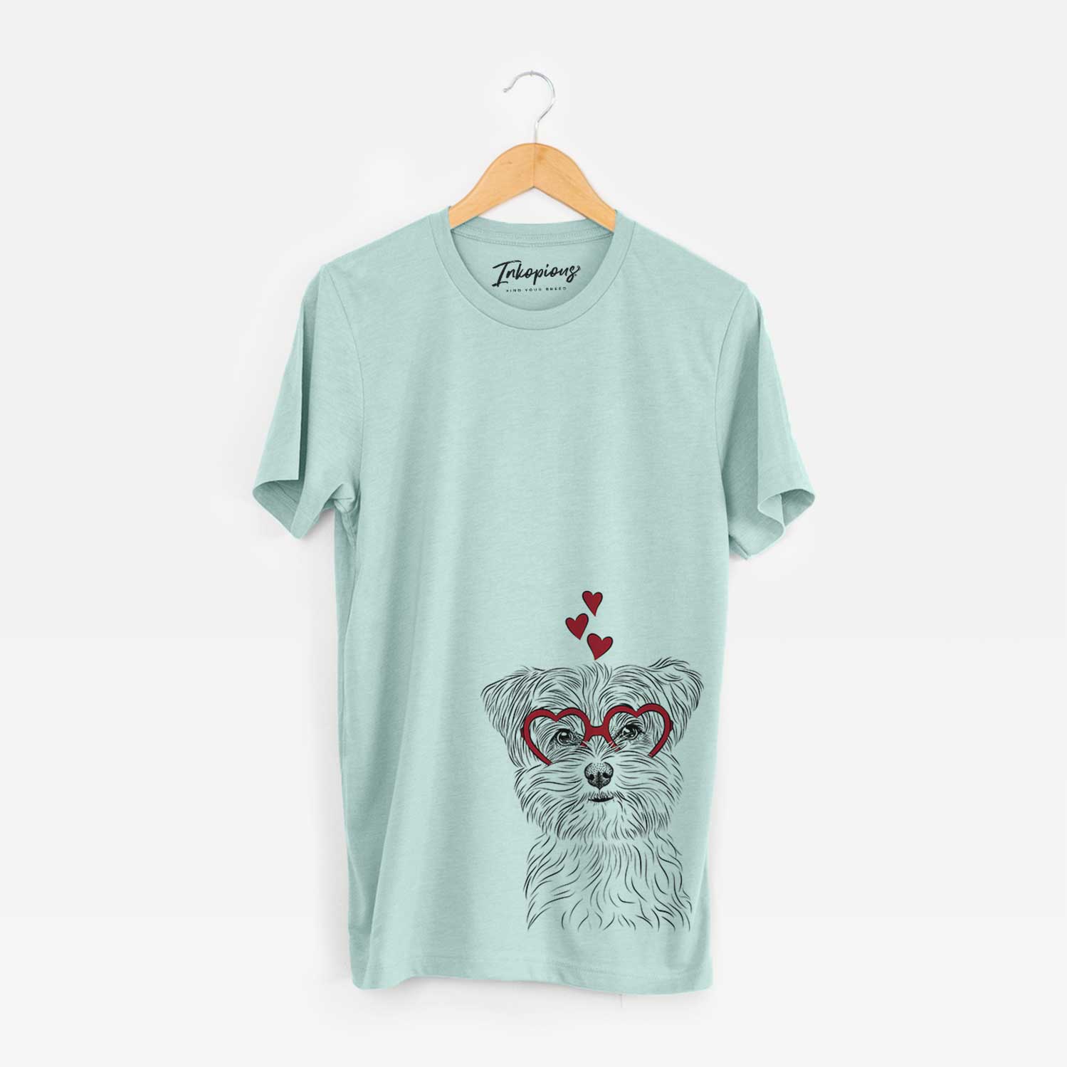 Hand-drawn sketch of Kiwi the Morkie wearing heart-shaped glasses on a Heather Sage Bella Canvas Unisex Crewneck