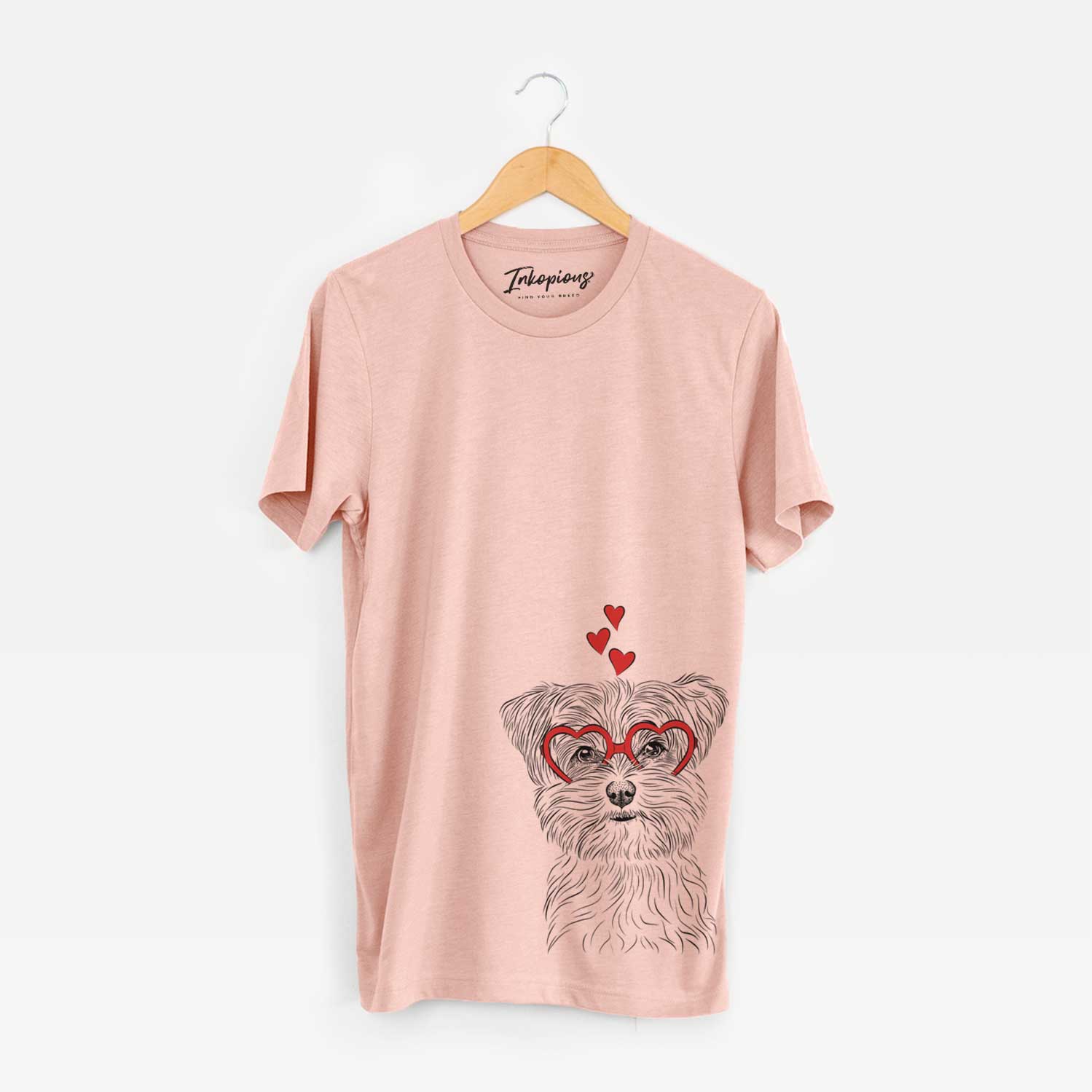 Hand-drawn sketch of Kiwi the Morkie wearing heart-shaped glasses on a Peach Unisex crewneck