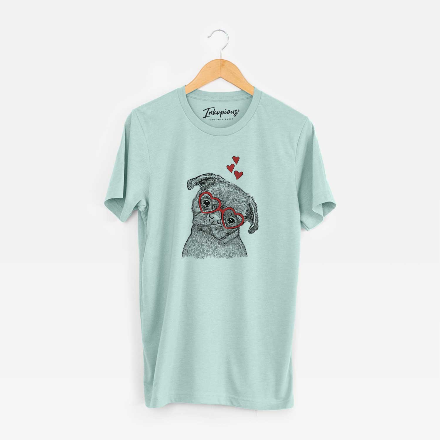 Hand-drawn sketch of Koko the Shih Tzu wearing heart-shaped glasses on a Heather Sage Unisex crewneck