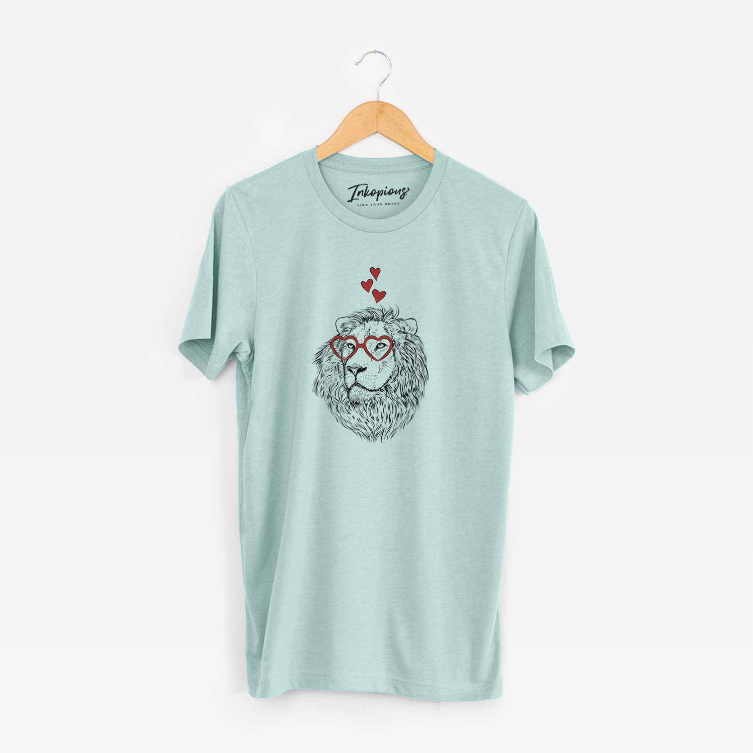 Hand-drawn sketch of Lenny the Lion wearing heart-shaped glasses on a Heather Sage Unisex crewneck