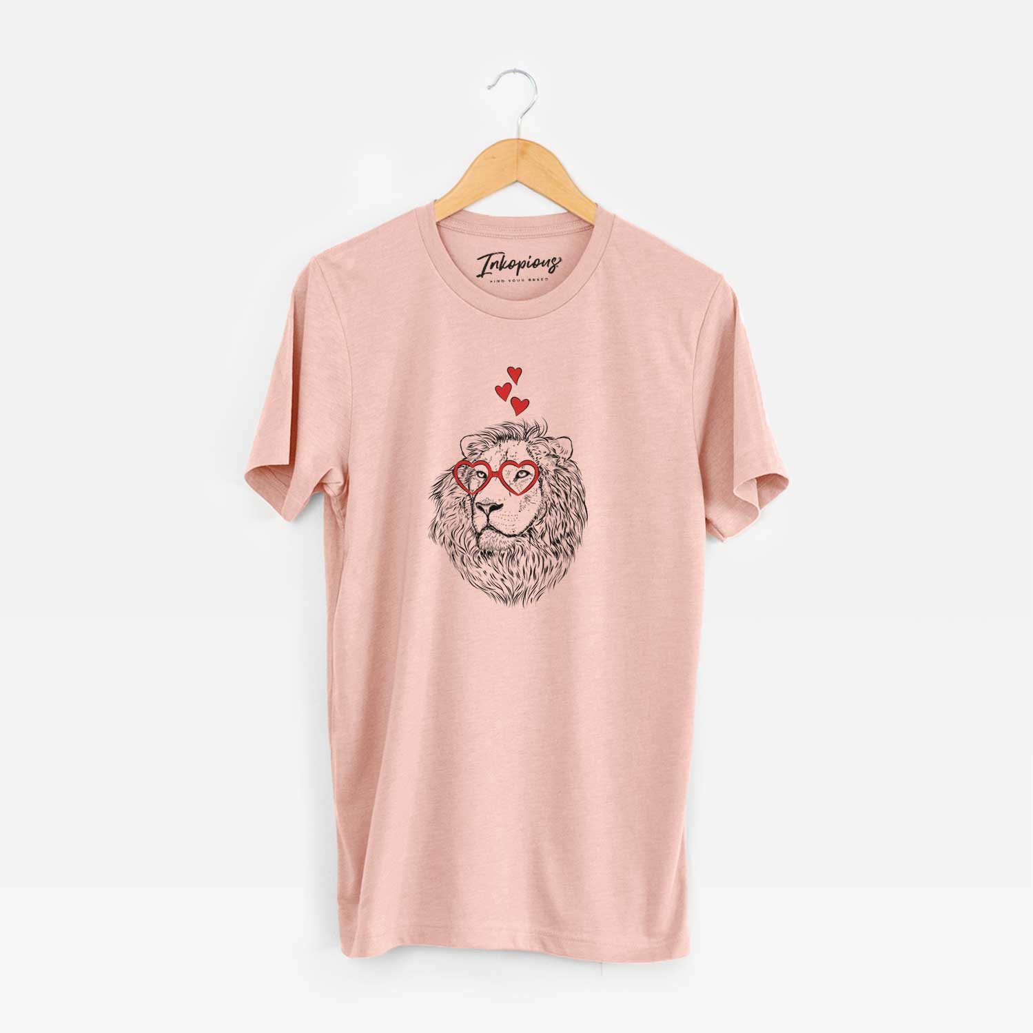 Hand-drawn sketch of Lenny the Lion wearing heart-shaped glasses on a Peach Unisex crewneck