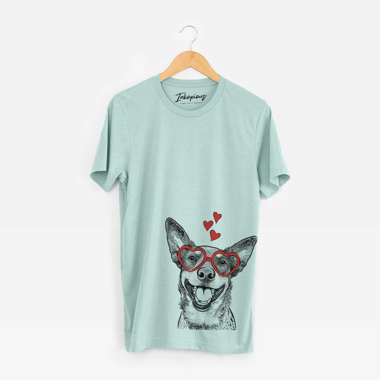 Hand-drawn sketch of Lily the Australian Cattle Dog wearing heart-shaped glasses on a Heather Sage Unisex crewneck