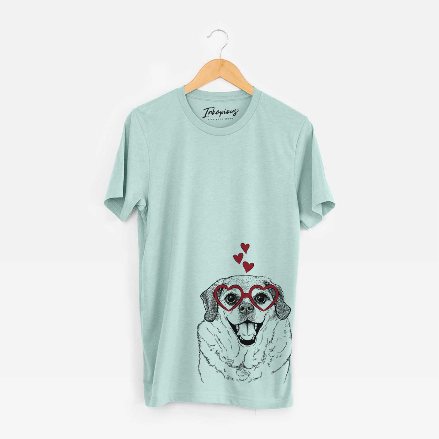 Hand-drawn sketch of LIttle Man the Puggle wearing heart-shaped glasses on a Heather Sage Bella Canvas Unisex Crewneck