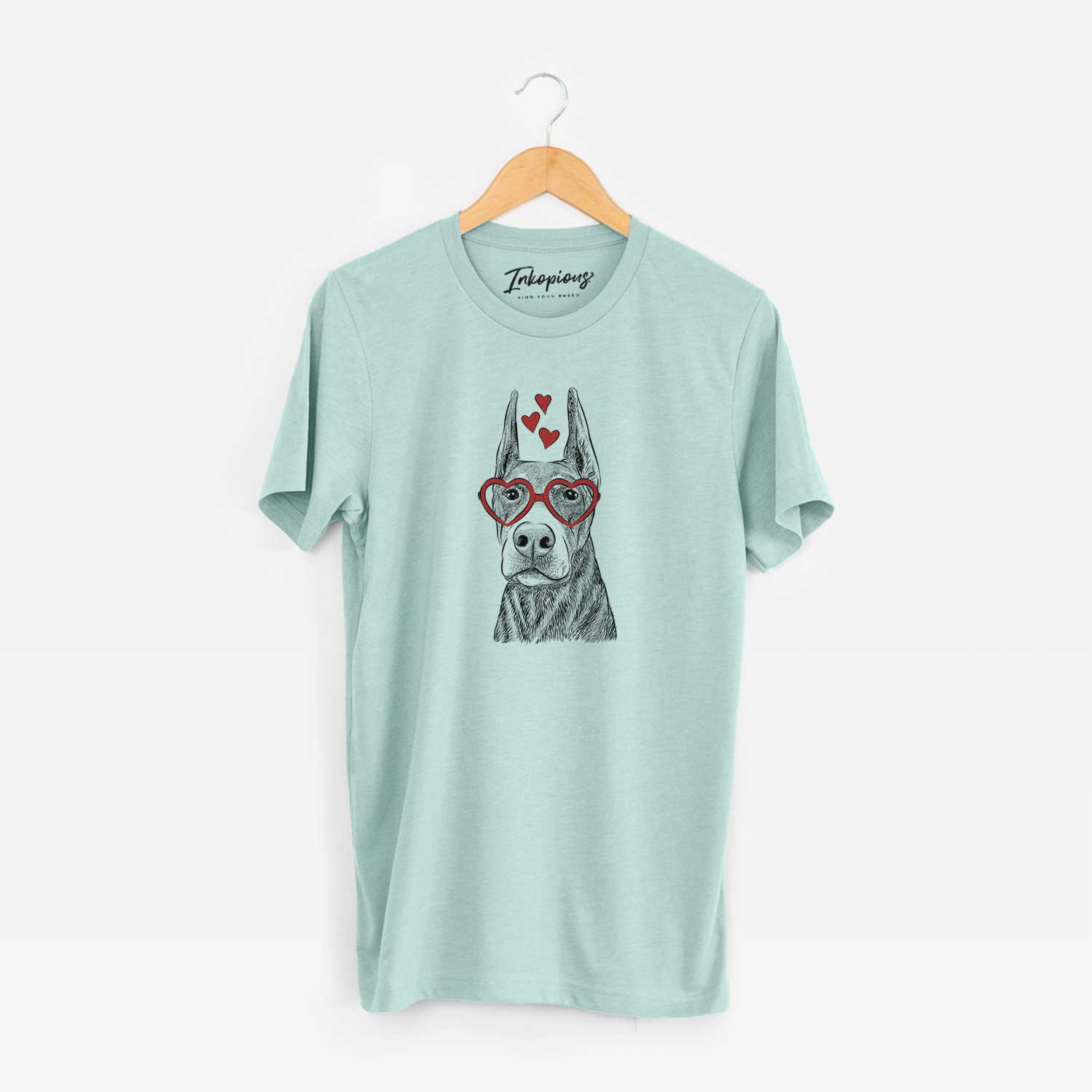 Hand-drawn sketch of Luna the Doberman Pinscher wearing heart-shaped glasses on a Heather Sage Unisex crewneck
