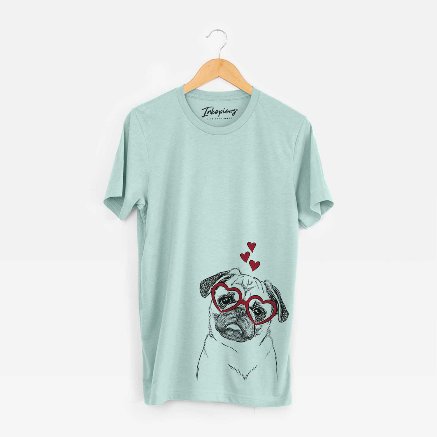 Hand-drawn sketch of Macy the Pug wearing heart-shaped glasses on a Heather Sage Bella Canvas Unisex Crewneck