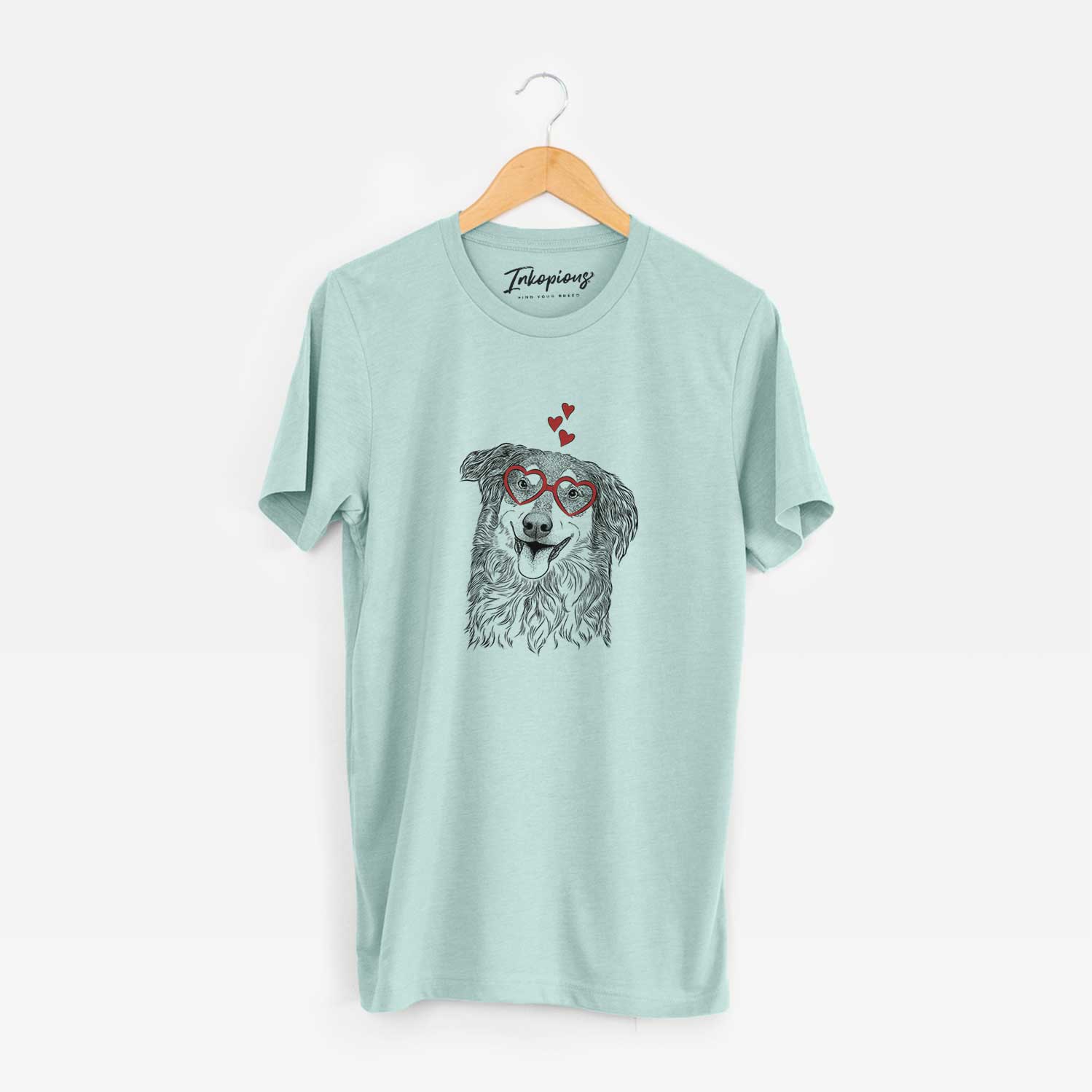 Hand-drawn sketch of Maddie the English Shepherd wearing heart-shaped glasses on a Heather Sage Unisex crewneck