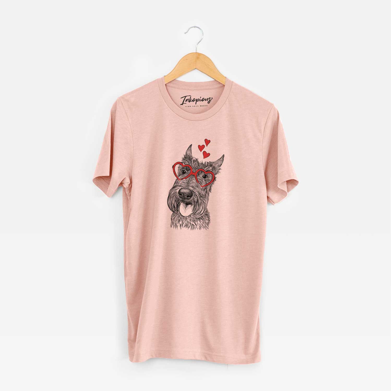 Hand-drawn sketch of Magnus the Scottish Terrier wearing heart-shaped glasses on a Peach Unisex crewneck