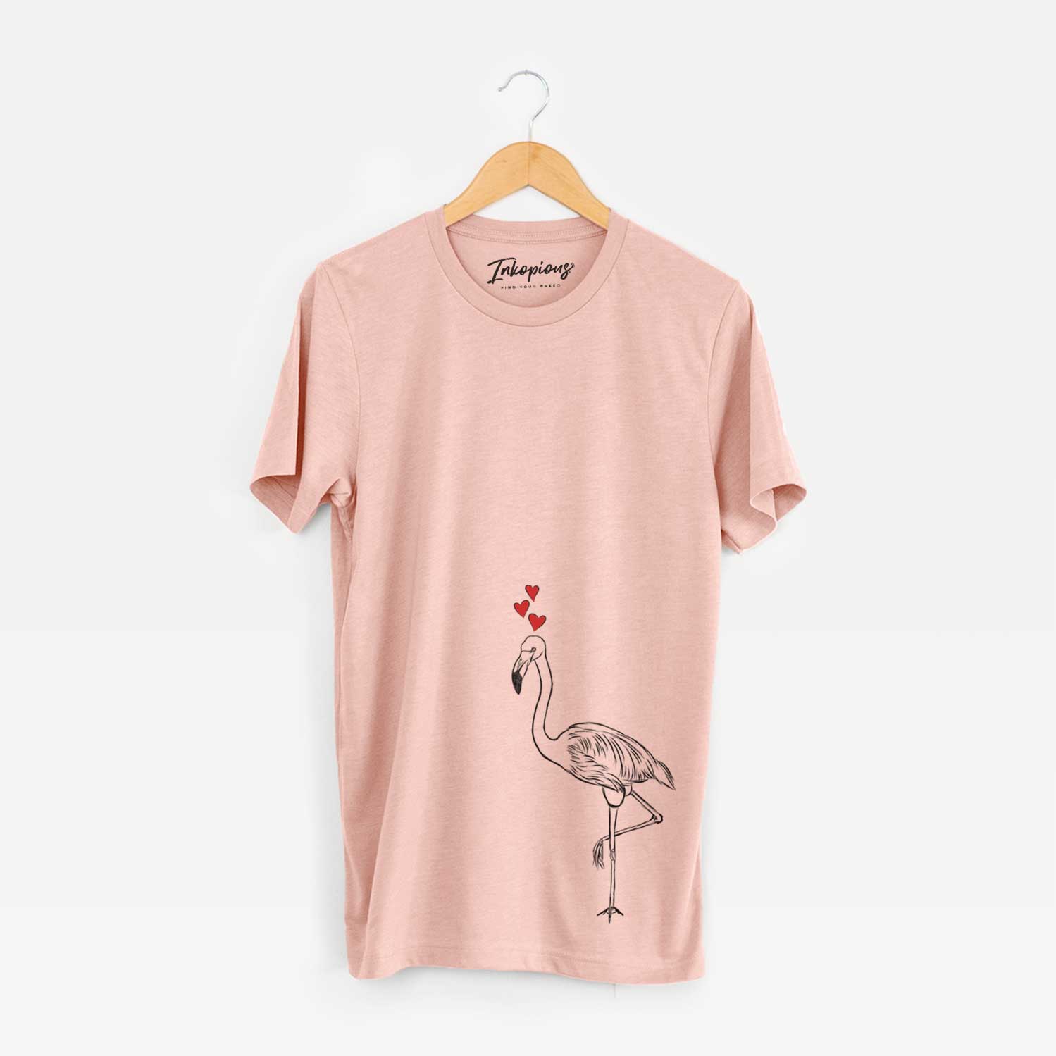Hand-drawn sketch of Mango the Flamingo wearing heart-shaped glasses on a Peach Unisex crewneck