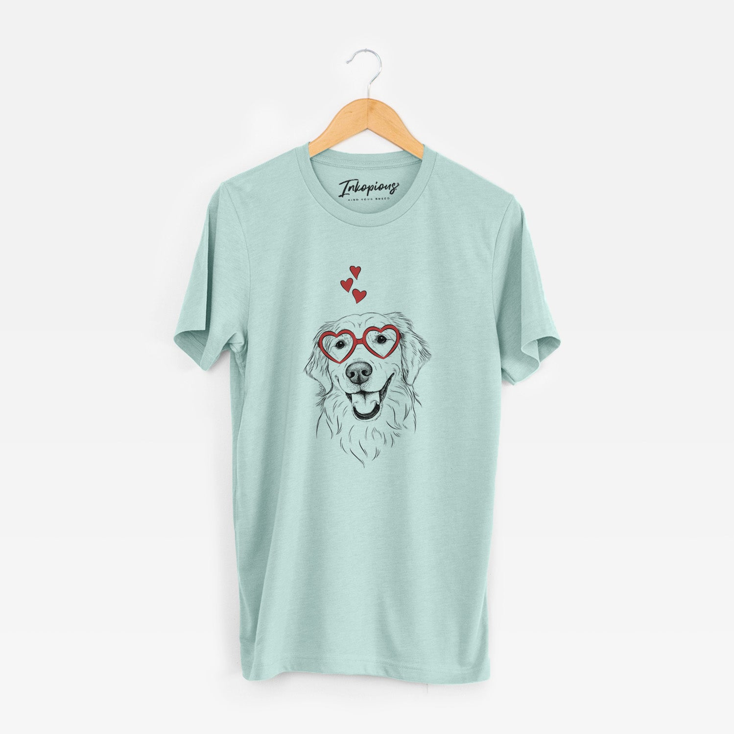 Hand-drawn sketch of Maple the Golden Retriever wearing heart-shaped glasses on a Heather Sage Unisex crewneck