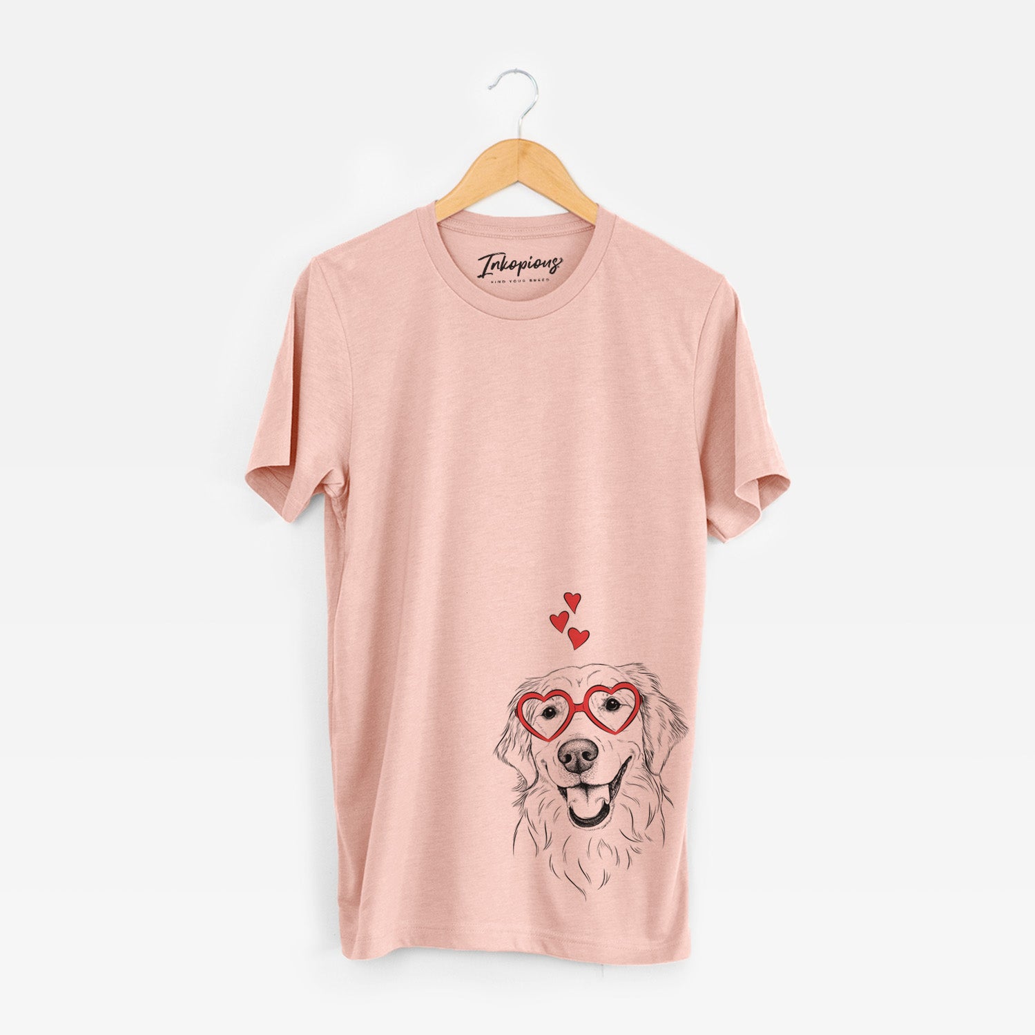 Hand-drawn sketch of Maple the Golden Retriever wearing heart-shaped glasses on a Peach Unisex crewneck