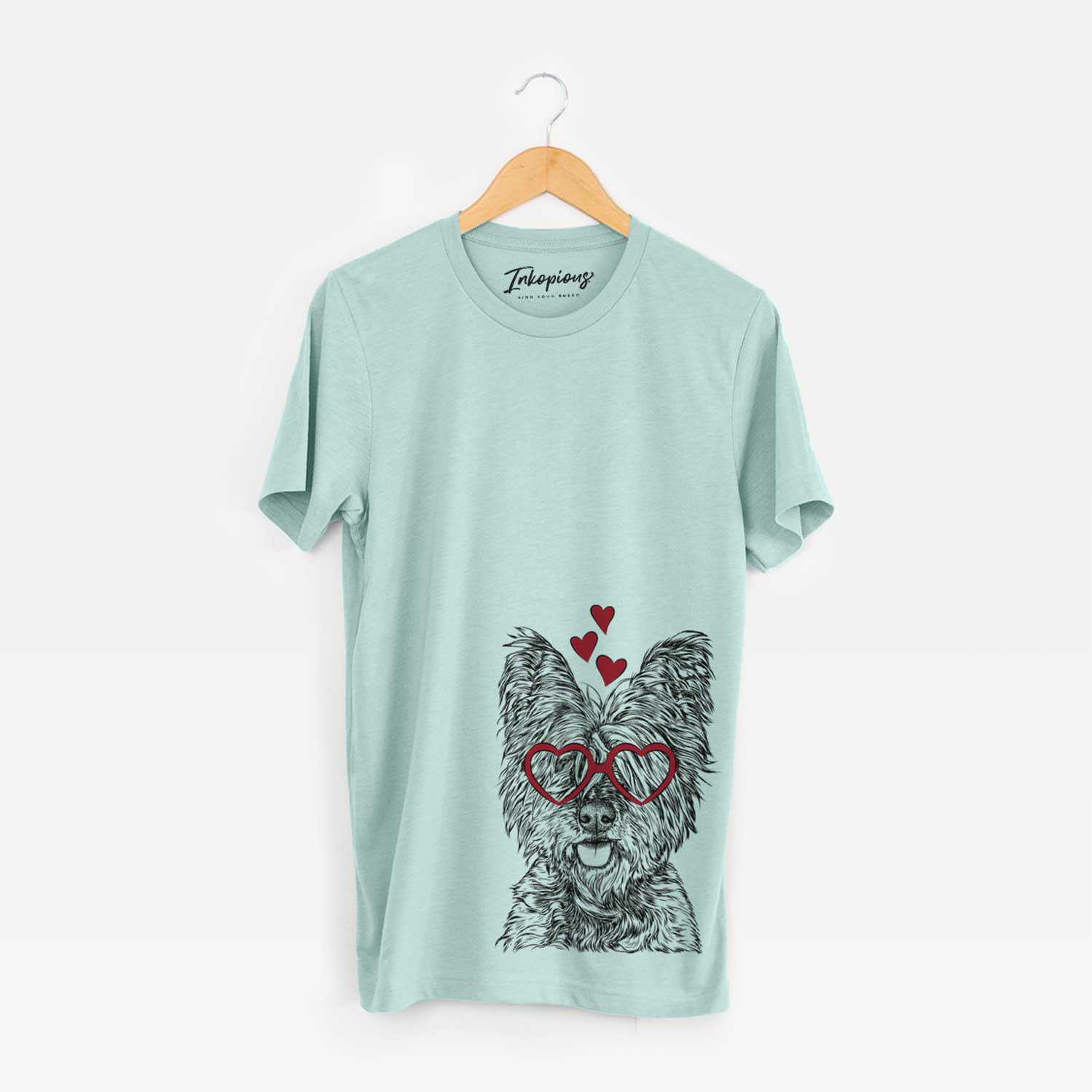 Hand-drawn sketch of McDuff the Cairn Terrier wearing heart-shaped glasses on a Heather Sage Bella Canvas Unisex Crewneck