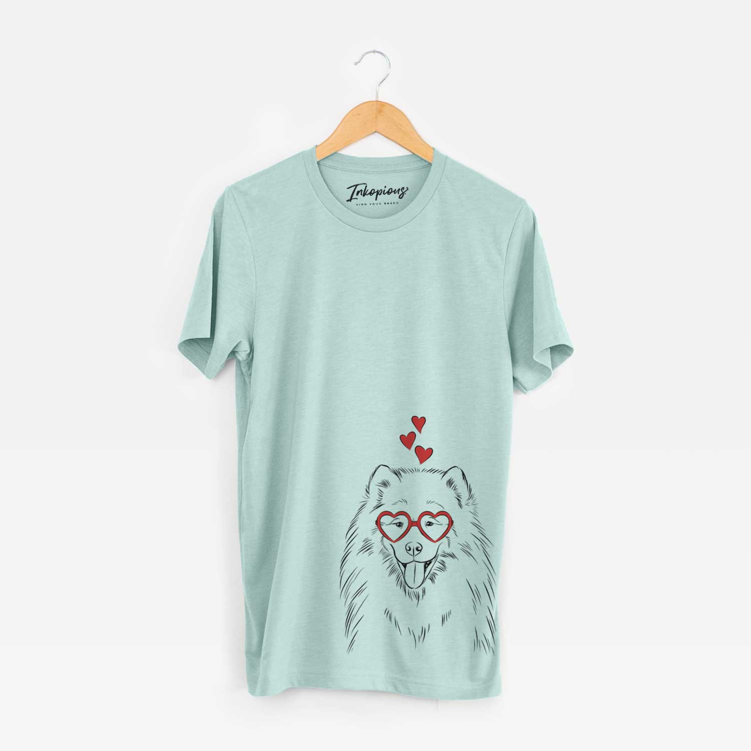 Hand-drawn sketch of Mikko the Samoyed wearing heart-shaped glasses on a Heather Sage Unisex crewneck