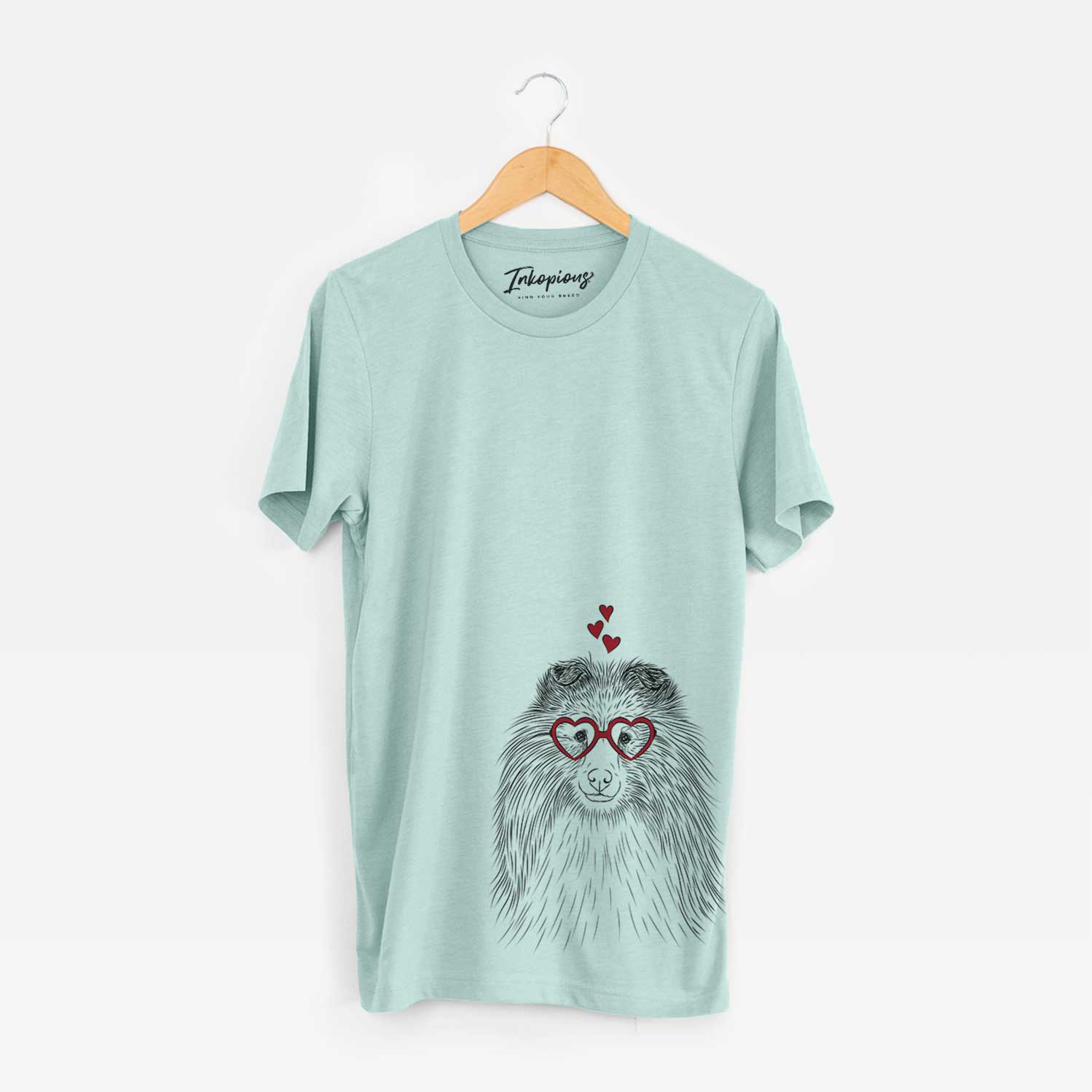 Hand-drawn sketch of Moxie the Shetland Sheepdog wearing heart-shaped glasses on a Heather Sage Bella Canvas Unisex Crewneck
