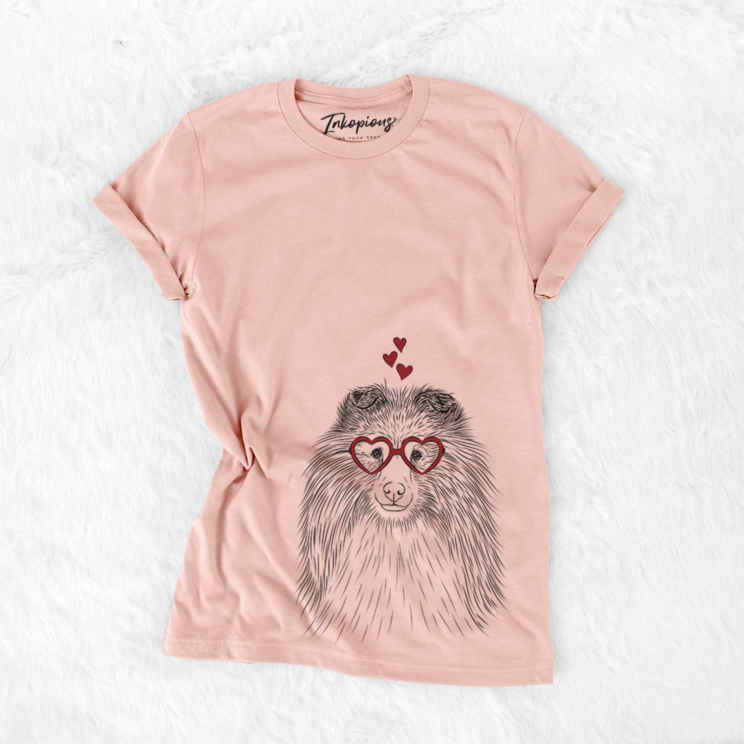 Hand-drawn sketch of Moxie the Shetland Sheepdog wearing heart-shaped glasses on a Peach Bella Canvas Unisex Crewneck
