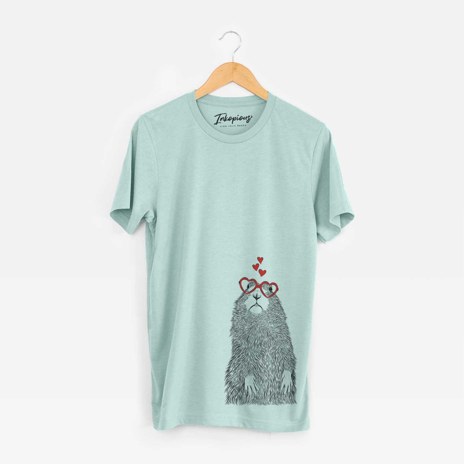 Hand-drawn sketch of Mr. Otis the Prairie Dog wearing heart-shaped glasses on a Heather Sage Unisex crewneck