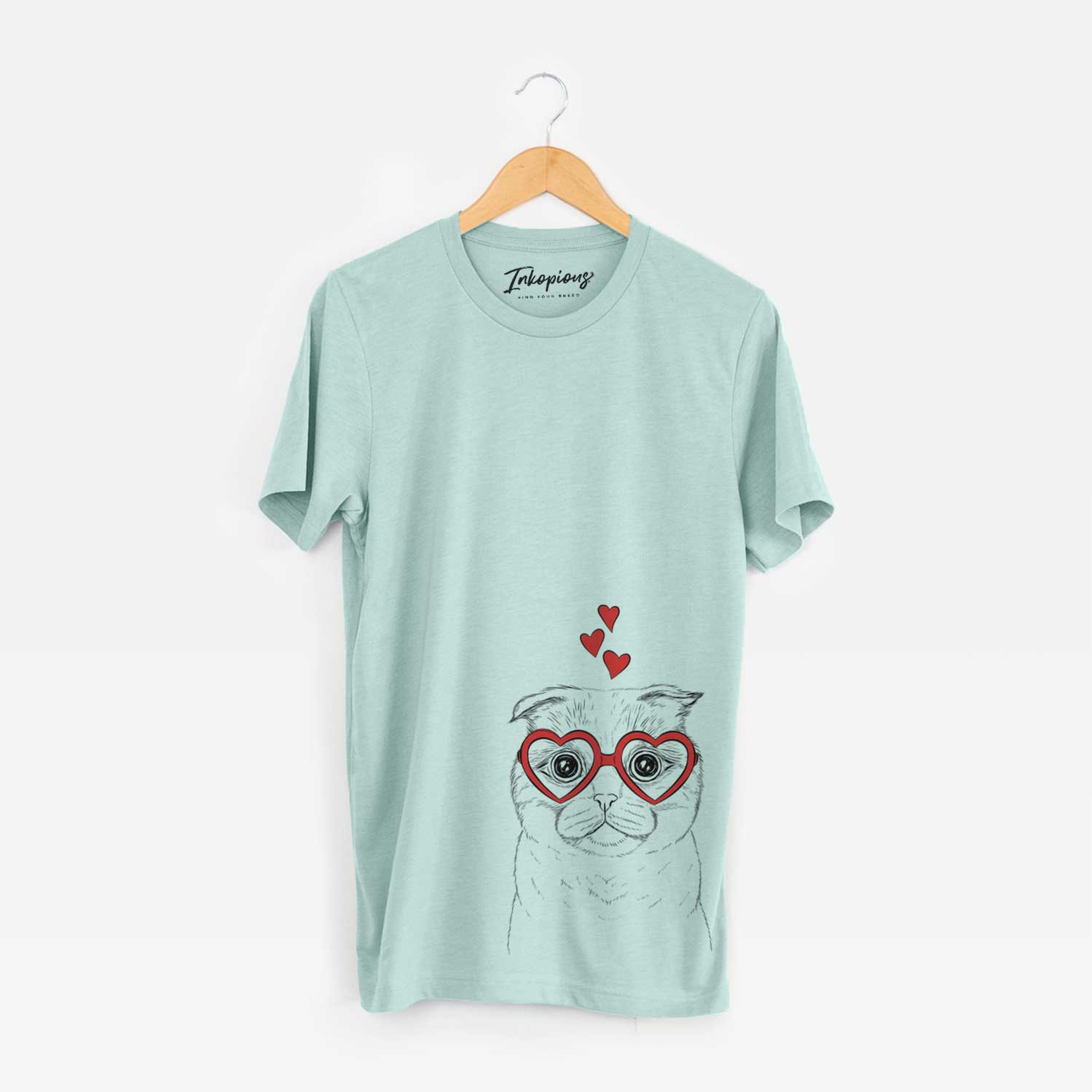 Hand-drawn sketch of Neko the Scottish Fold Cat wearing heart-shaped glasses on a Heather Sage Unisex crewneck
