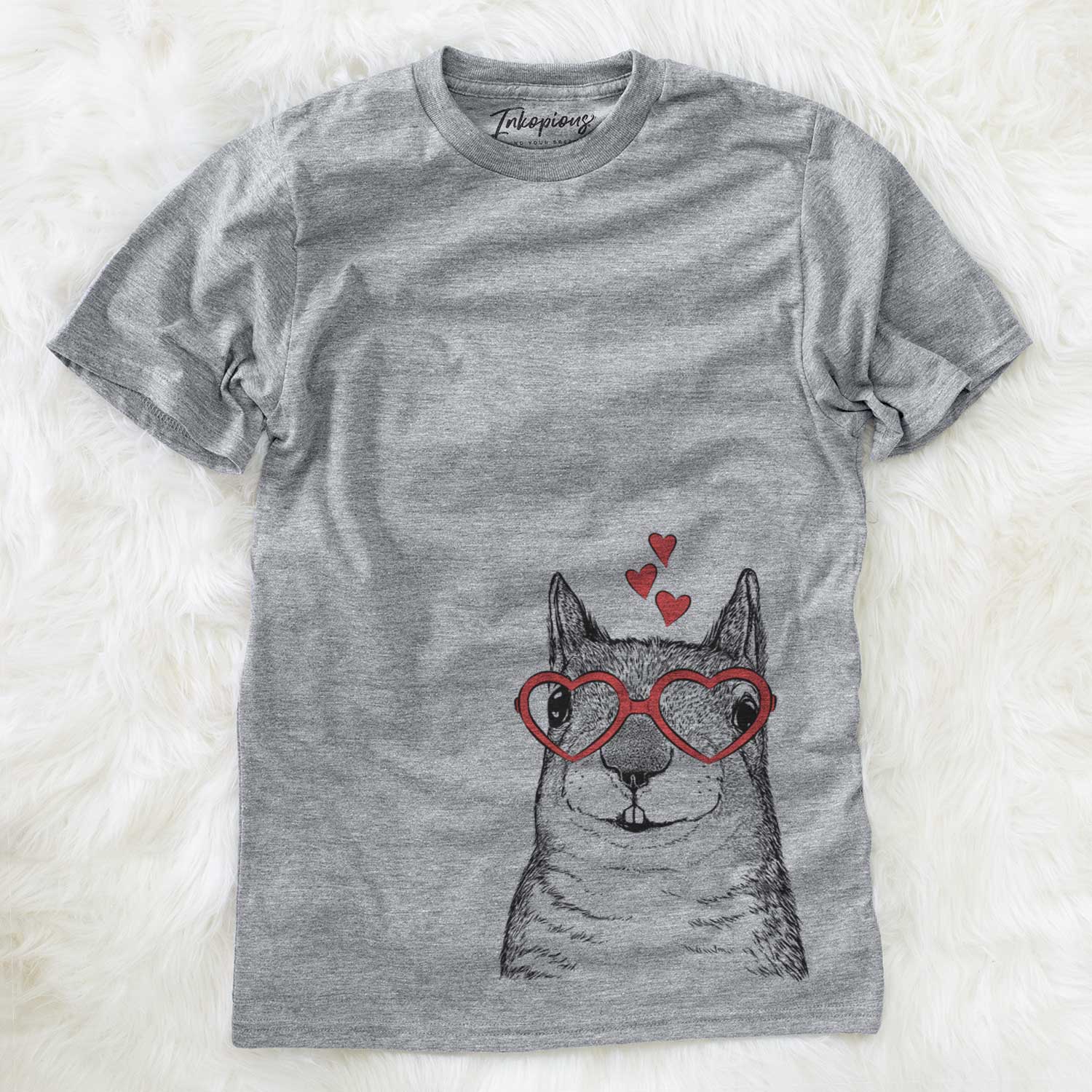 Hand-drawn sketch of Nibbles the Squirrel wearing heart-shaped glasses on a Grey Unisex crewneck