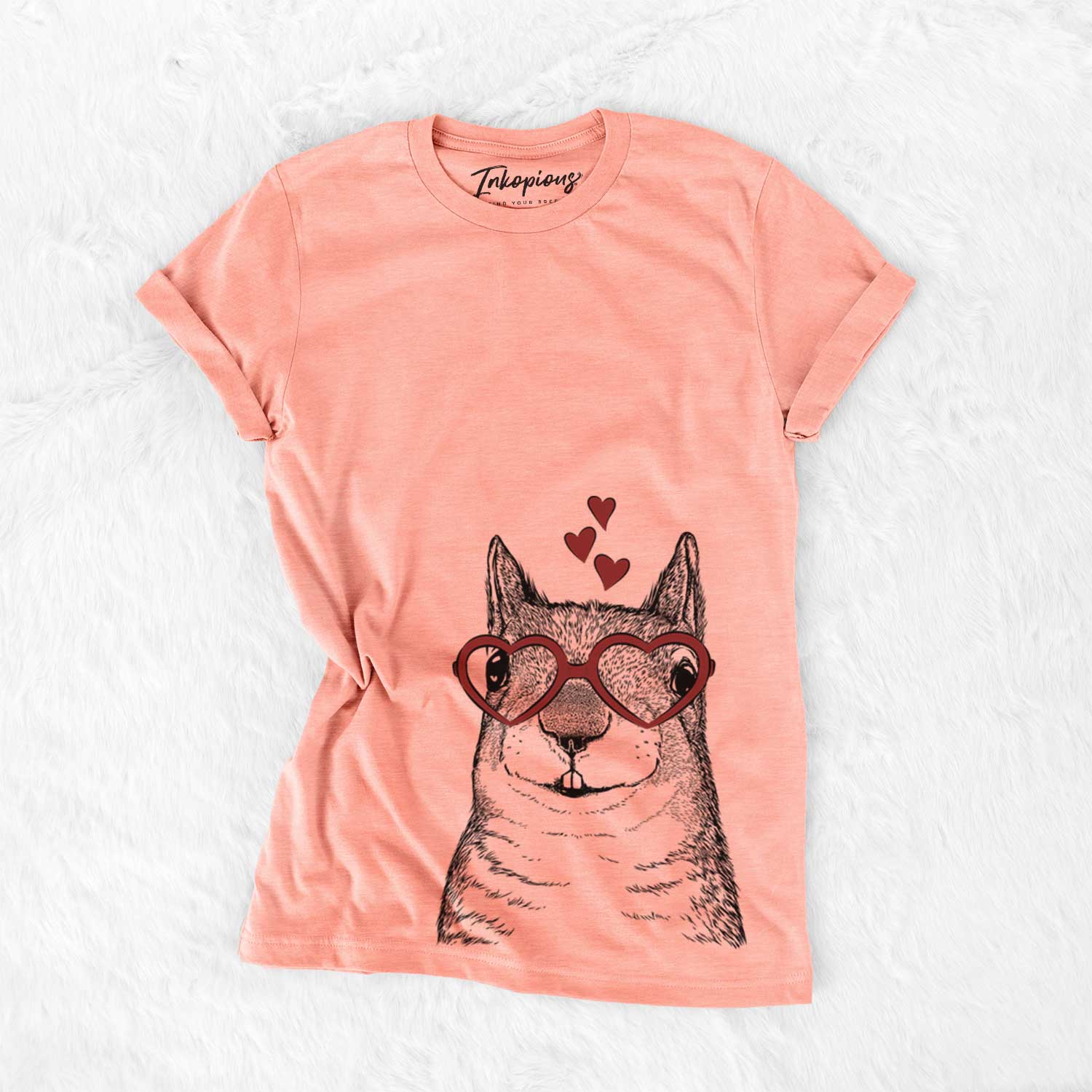 Hand-drawn sketch of Nibbles the Squirrel wearing heart-shaped glasses on a Sunset Bella Canvas Unisex Crewneck