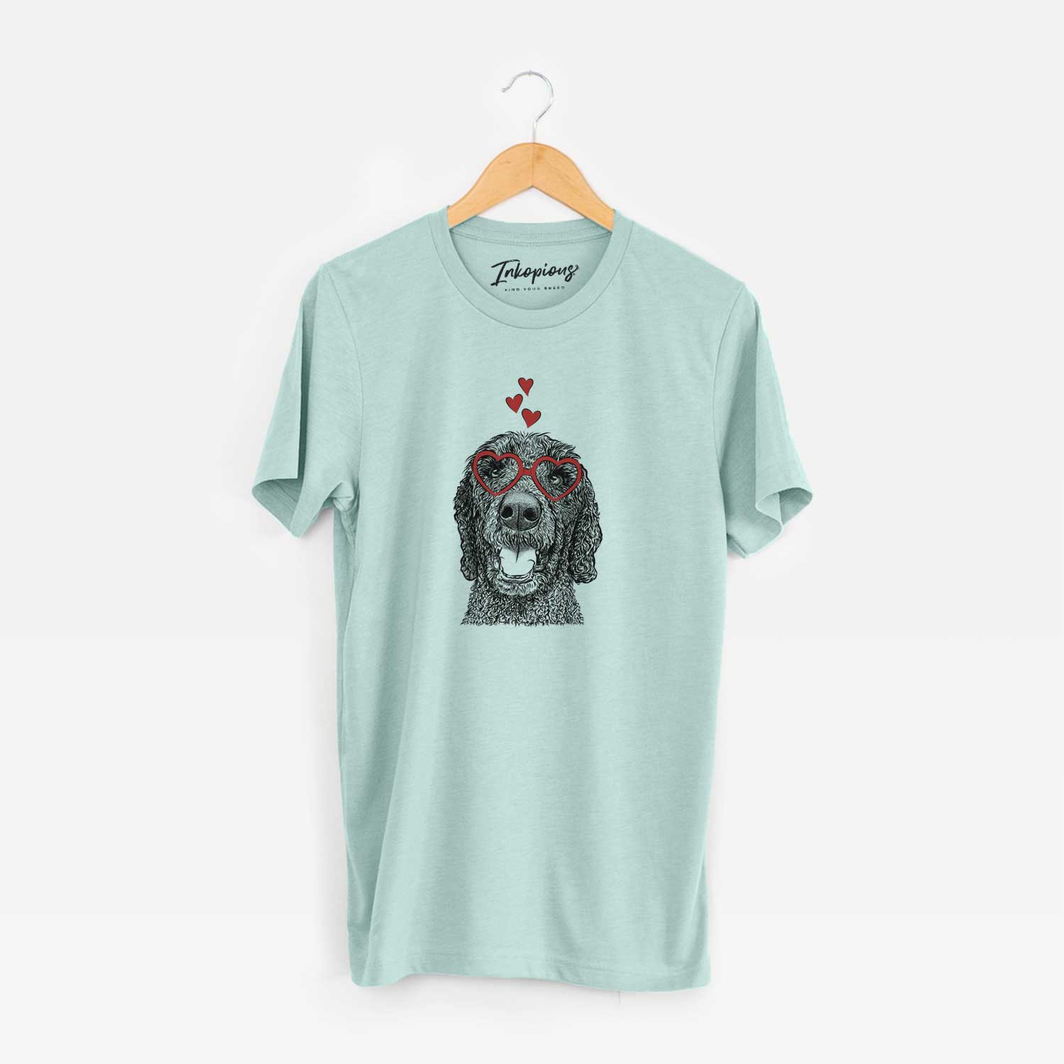 Hand-drawn sketch of Obi James the Goldendoodle wearing heart-shaped glasses on a Heather Sage Unisex crewneck