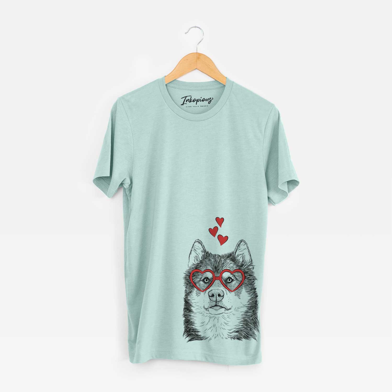 Hand-drawn sketch of Oskar the Canadian Eskimo Dog wearing heart-shaped glasses on a Heather Sage Unisex crewneck