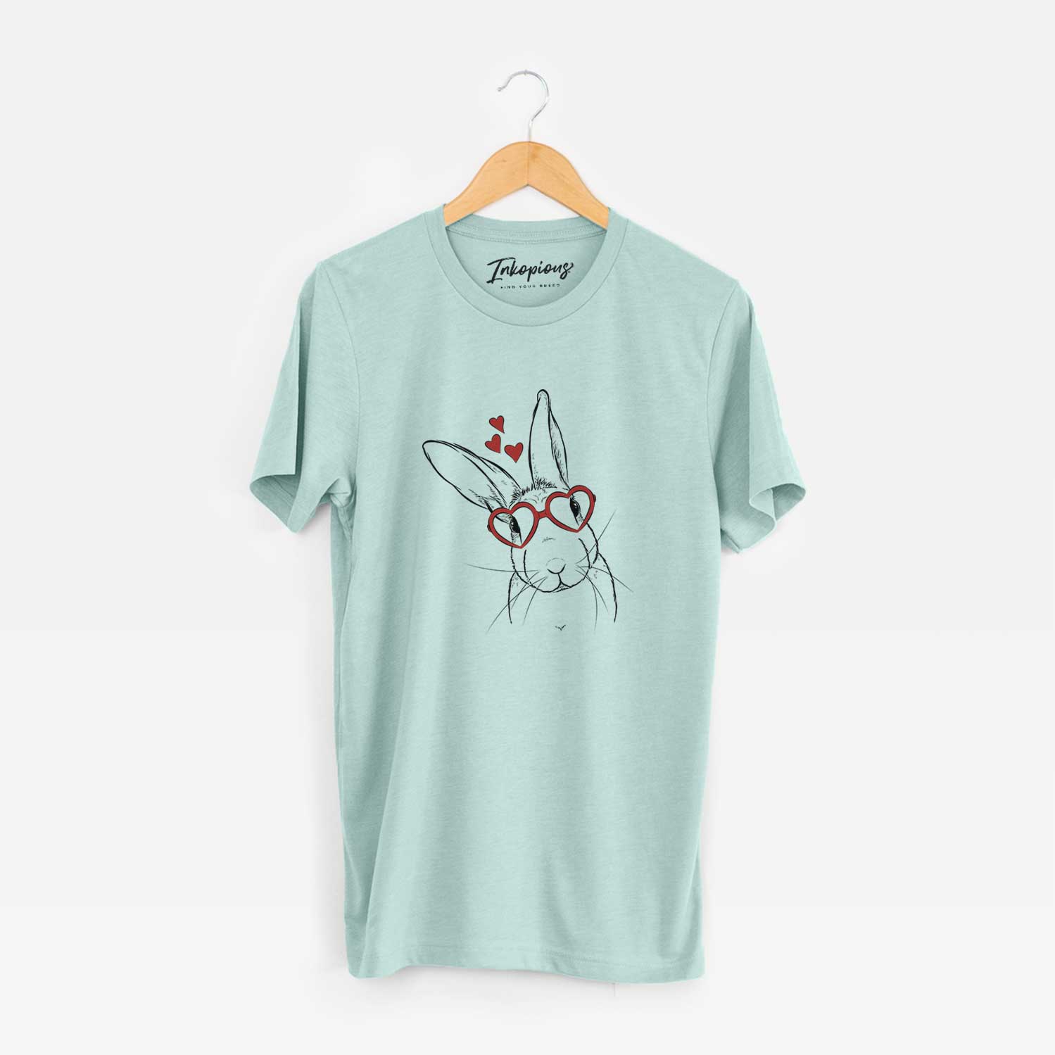 Hand-drawn sketch of Penny the Belgian Hare wearing heart-shaped glasses on a Heather Sage Unisex crewneck