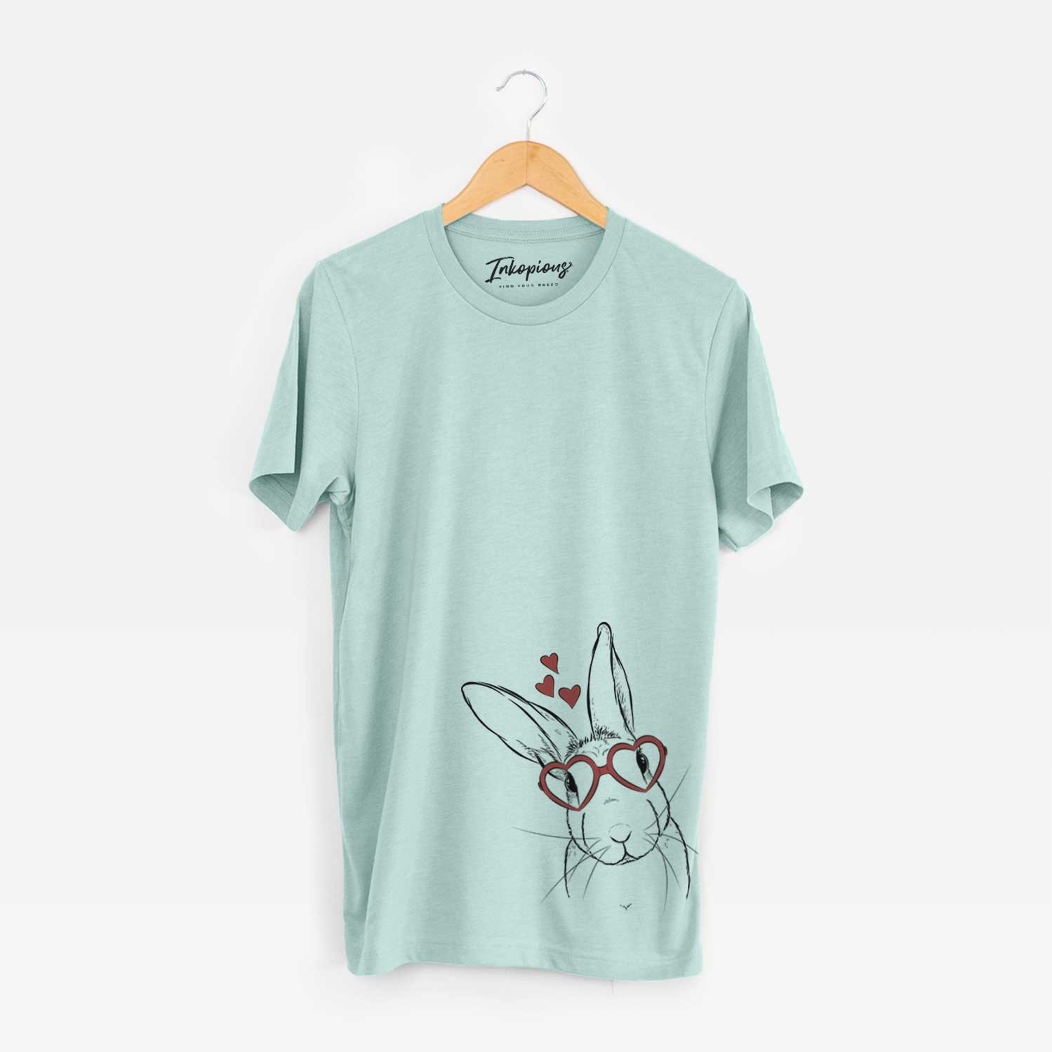 Hand-drawn sketch of Penny the Belgian Hare wearing heart-shaped glasses on a Heather Sage Unisex crewneck