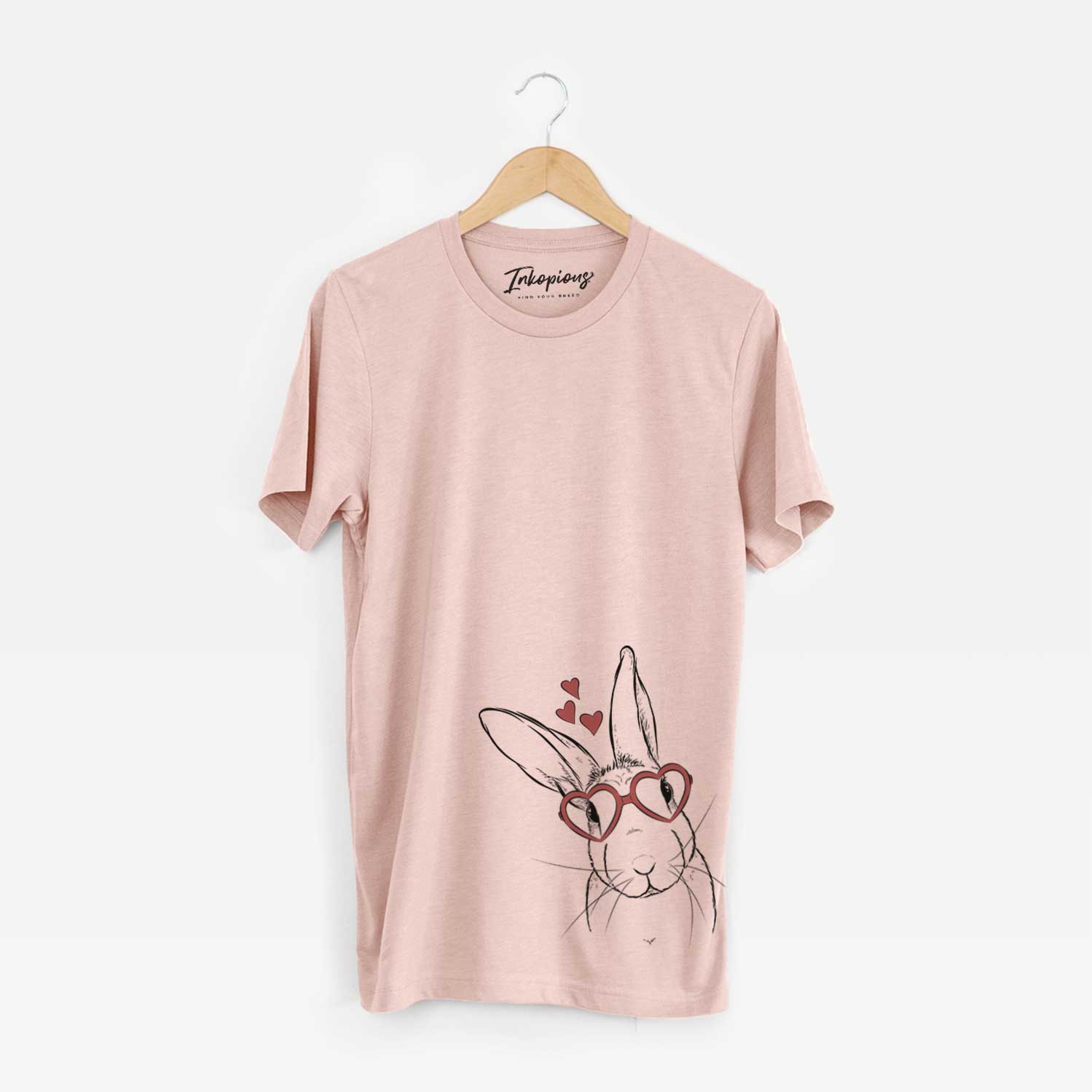 Hand-drawn sketch of Penny the Belgian Hare wearing heart-shaped glasses on a Peach Unisex crewneck