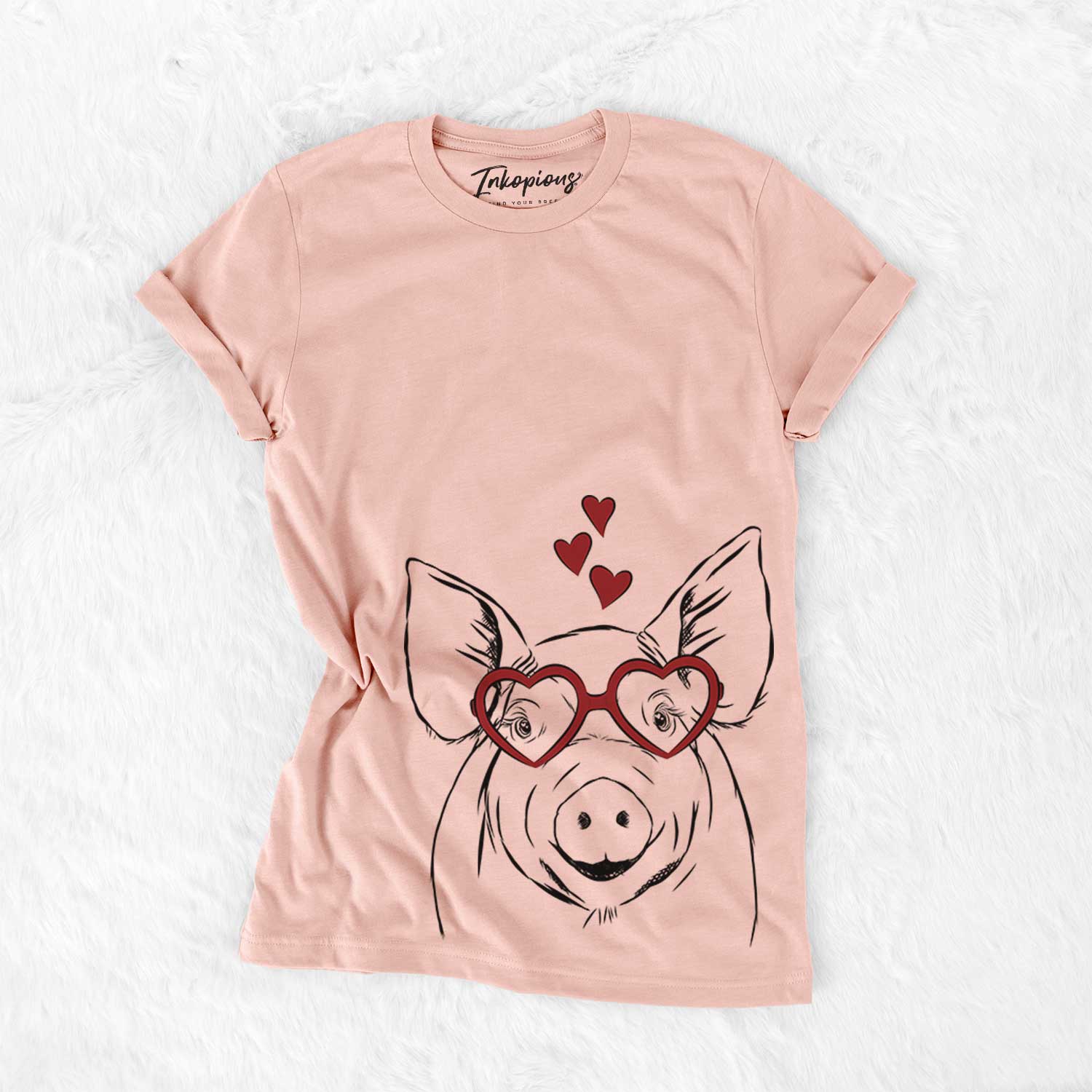 Hand-drawn sketch of Perry the Pig wearing heart-shaped glasses on a Peach Bella Canvas Unisex Crewneck