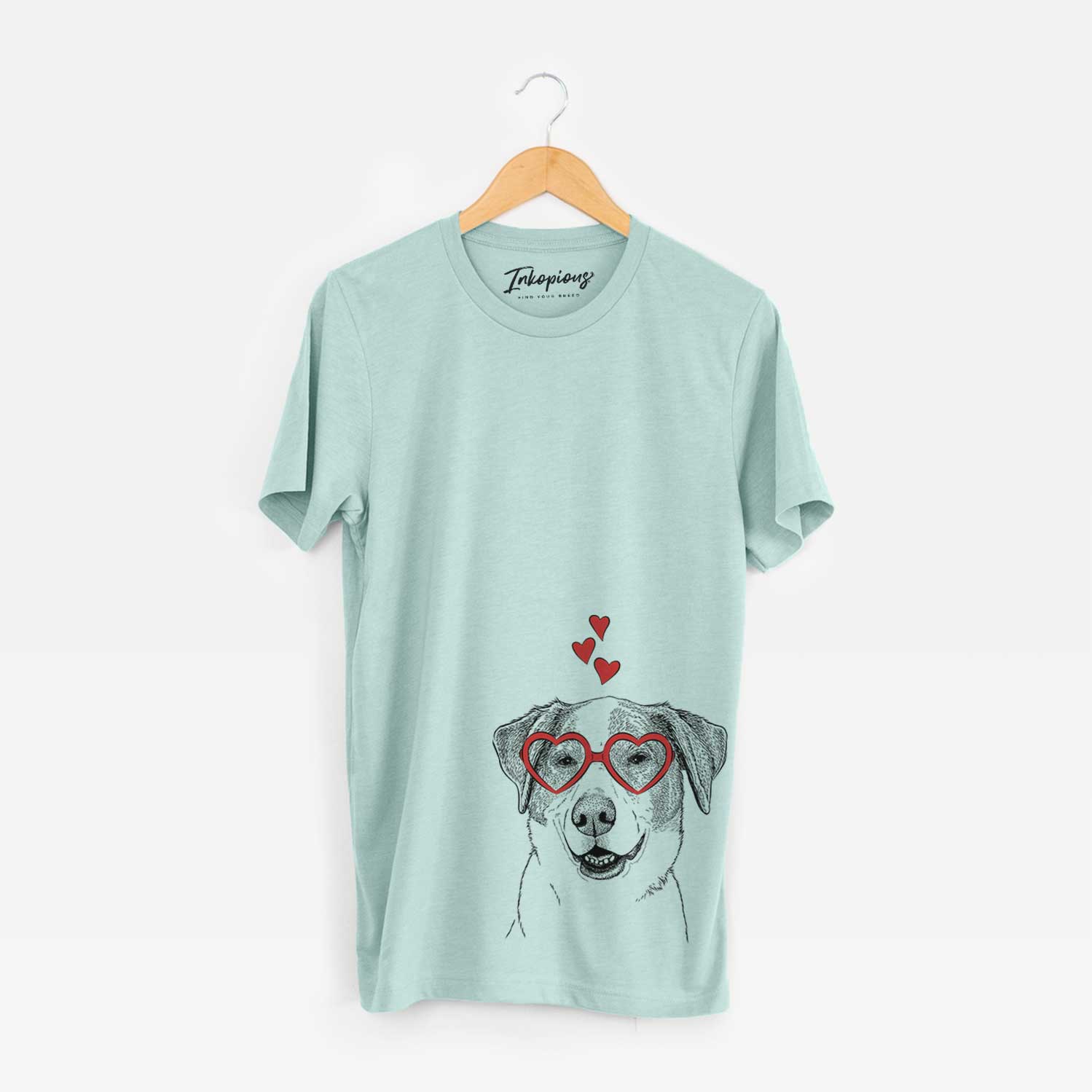 Hand-drawn sketch of Piper Pilot the Hound Mix wearing heart-shaped glasses on a Heather Sage Unisex crewneck