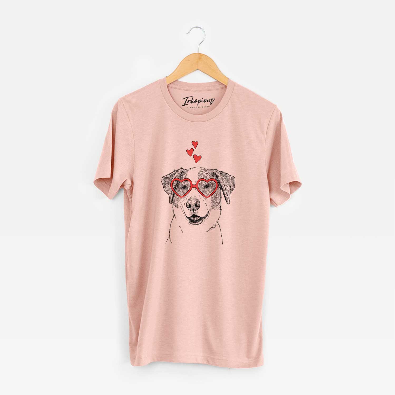 Hand-drawn sketch of Piper Pilot the Hound Mix wearing heart-shaped glasses on a Peach Unisex crewneck