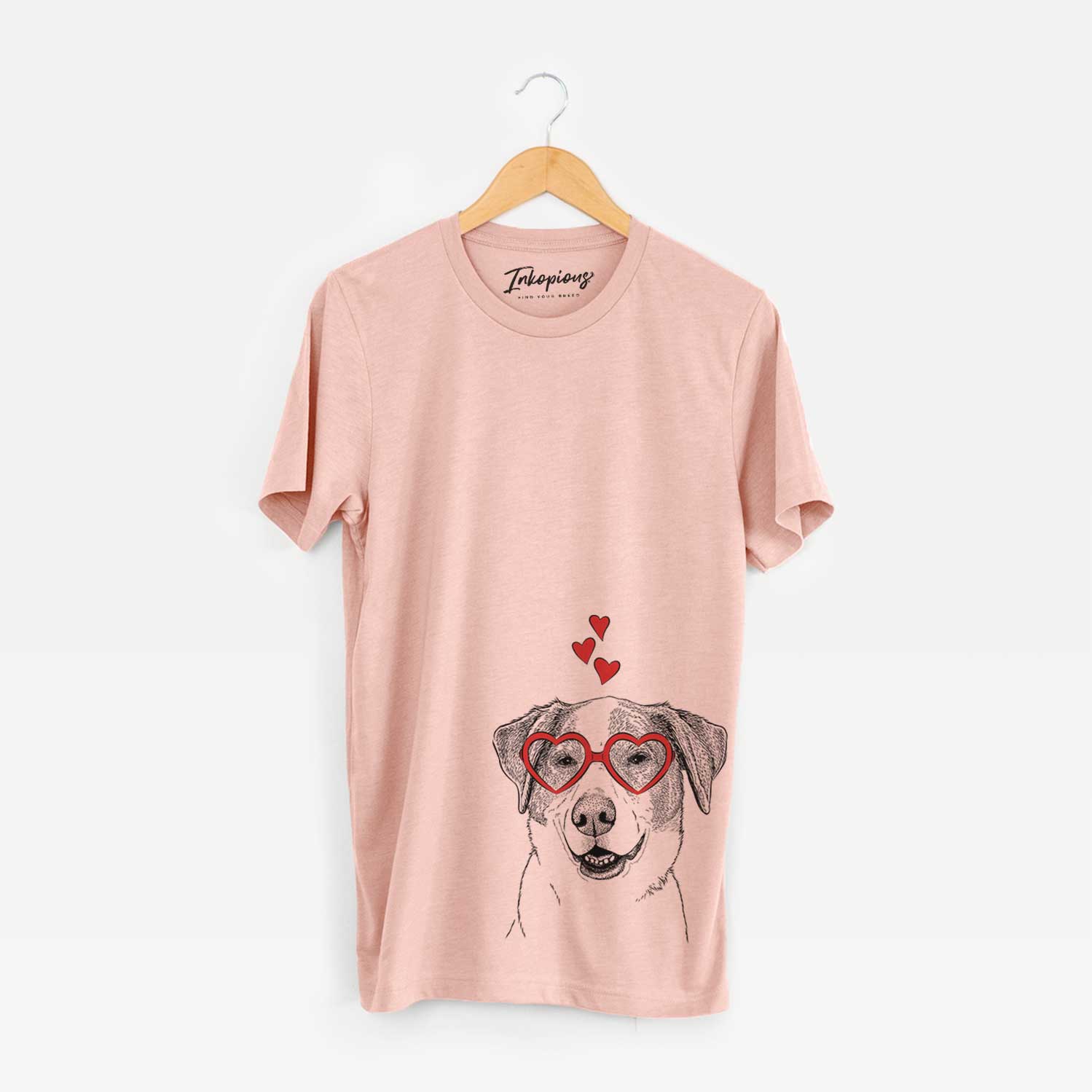 Hand-drawn sketch of Piper Pilot the Hound Mix wearing heart-shaped glasses on a Peach Unisex crewneck