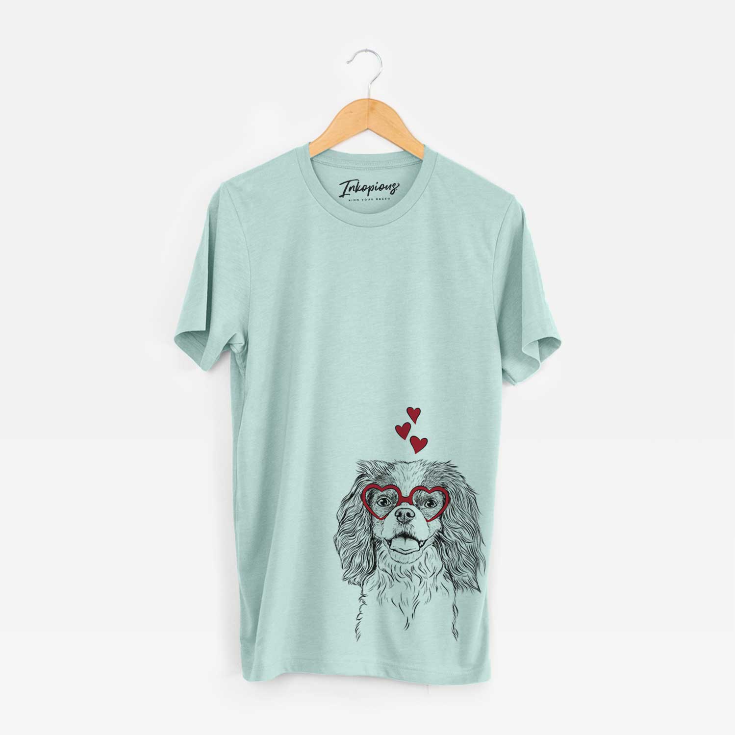Hand-drawn sketch of Poppy the Cavalier King Charles Spaniel wearing heart-shaped glasses on a Heather Sage Bella Canvas Unisex Crewneck