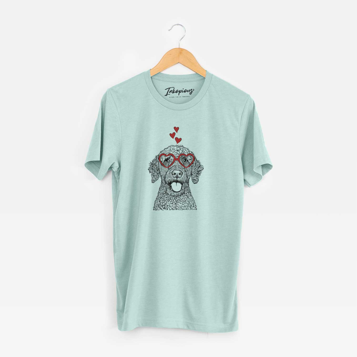 Hand-drawn sketch of Reina the Spanish Water Dog wearing heart-shaped glasses on a Heather Sage Unisex crewneck