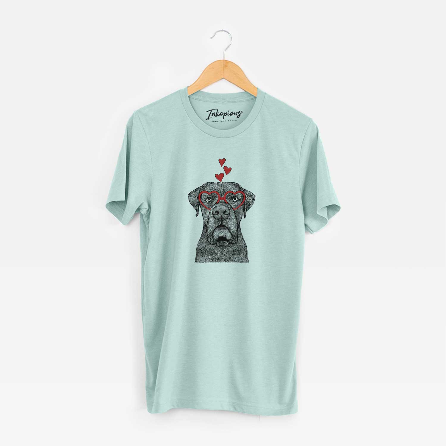 Hand-drawn sketch of Rocco the Cane Corso wearing heart-shaped glasses on a Heather Sage Unisex crewneck