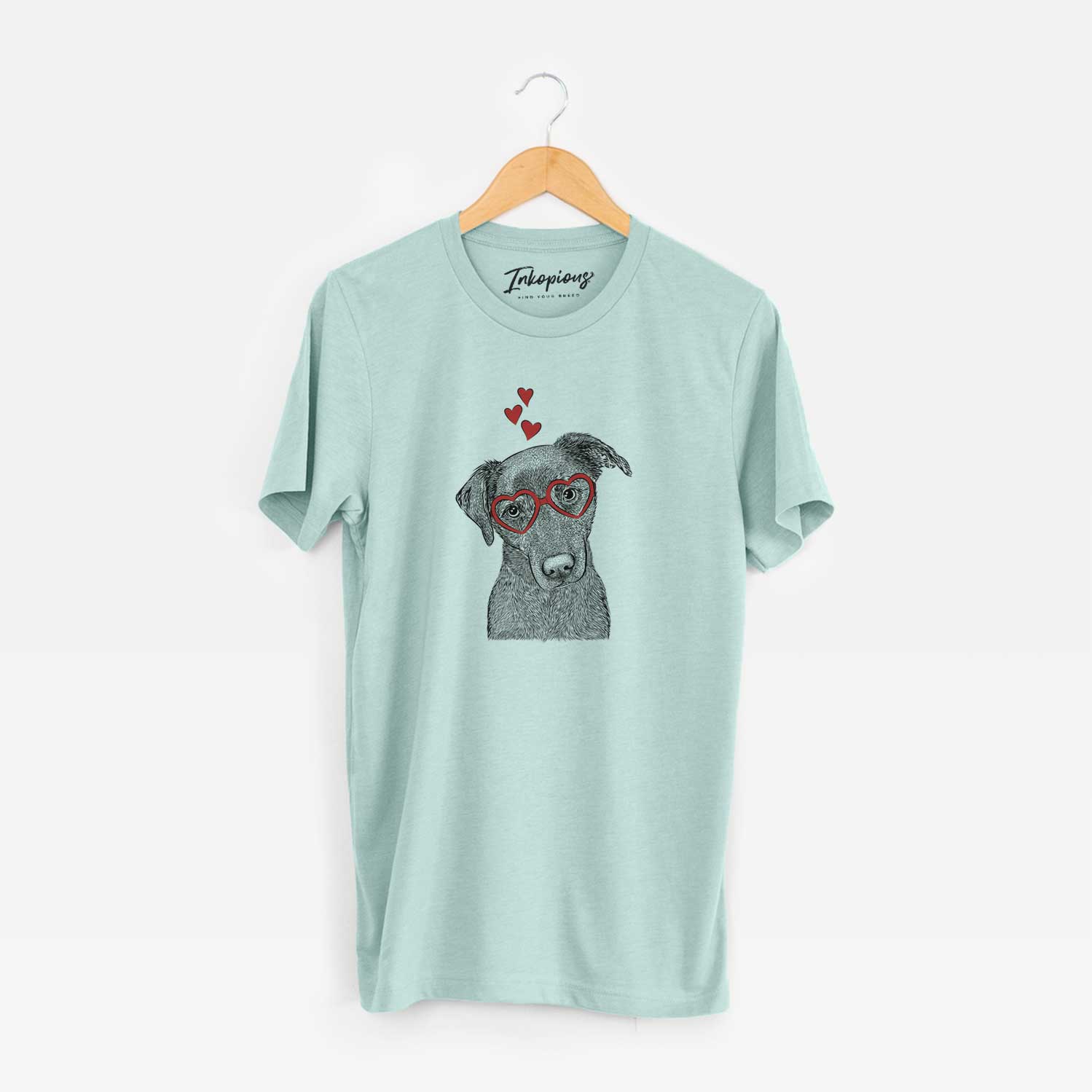 Hand-drawn sketch of Sadie the Whipador wearing heart-shaped glasses on a Heather Sage Unisex crewneck