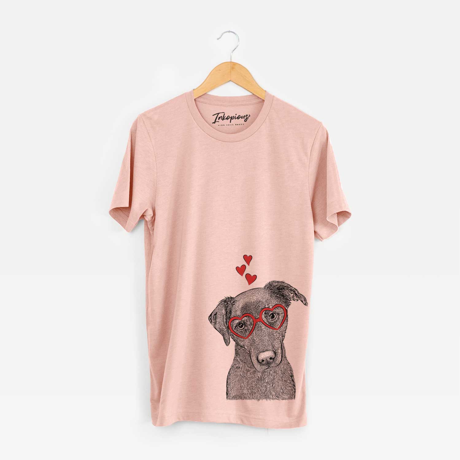 Hand-drawn sketch of Sadie the Whipador wearing heart-shaped glasses on a Peach Unisex crewneck