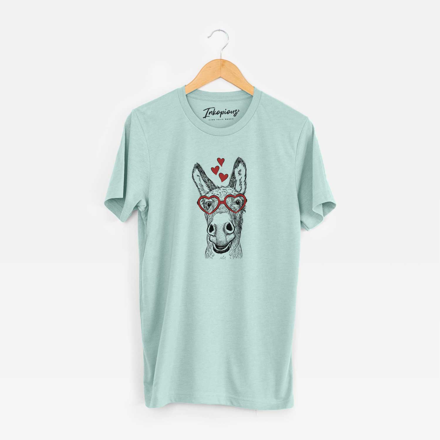 Hand-drawn sketch of Samule the Donkey wearing heart-shaped glasses on a Heather Sage Unisex crewneck