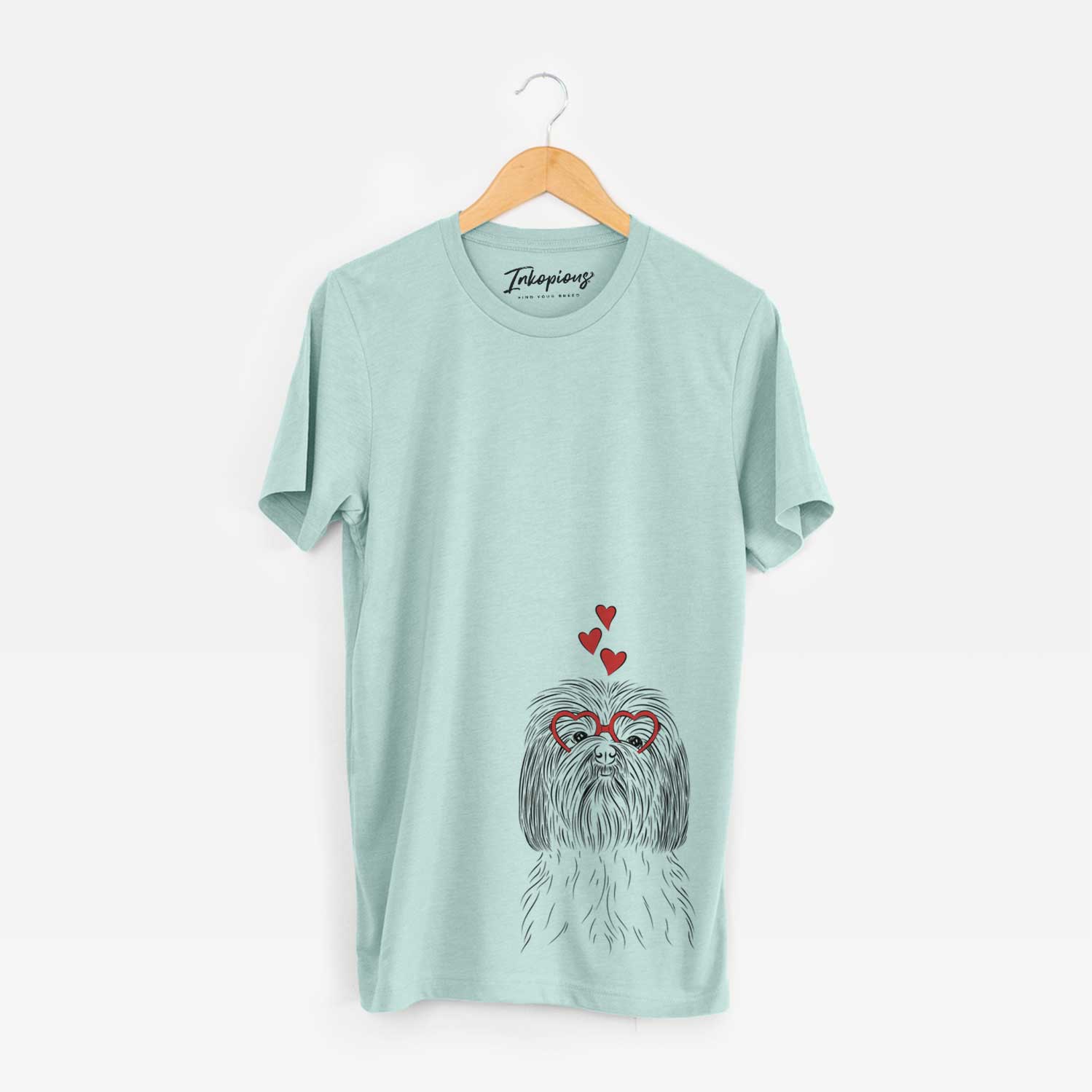 Hand-drawn sketch of Scully the Shih Tzu wearing heart-shaped glasses on a Heather Sage Unisex crewneck
