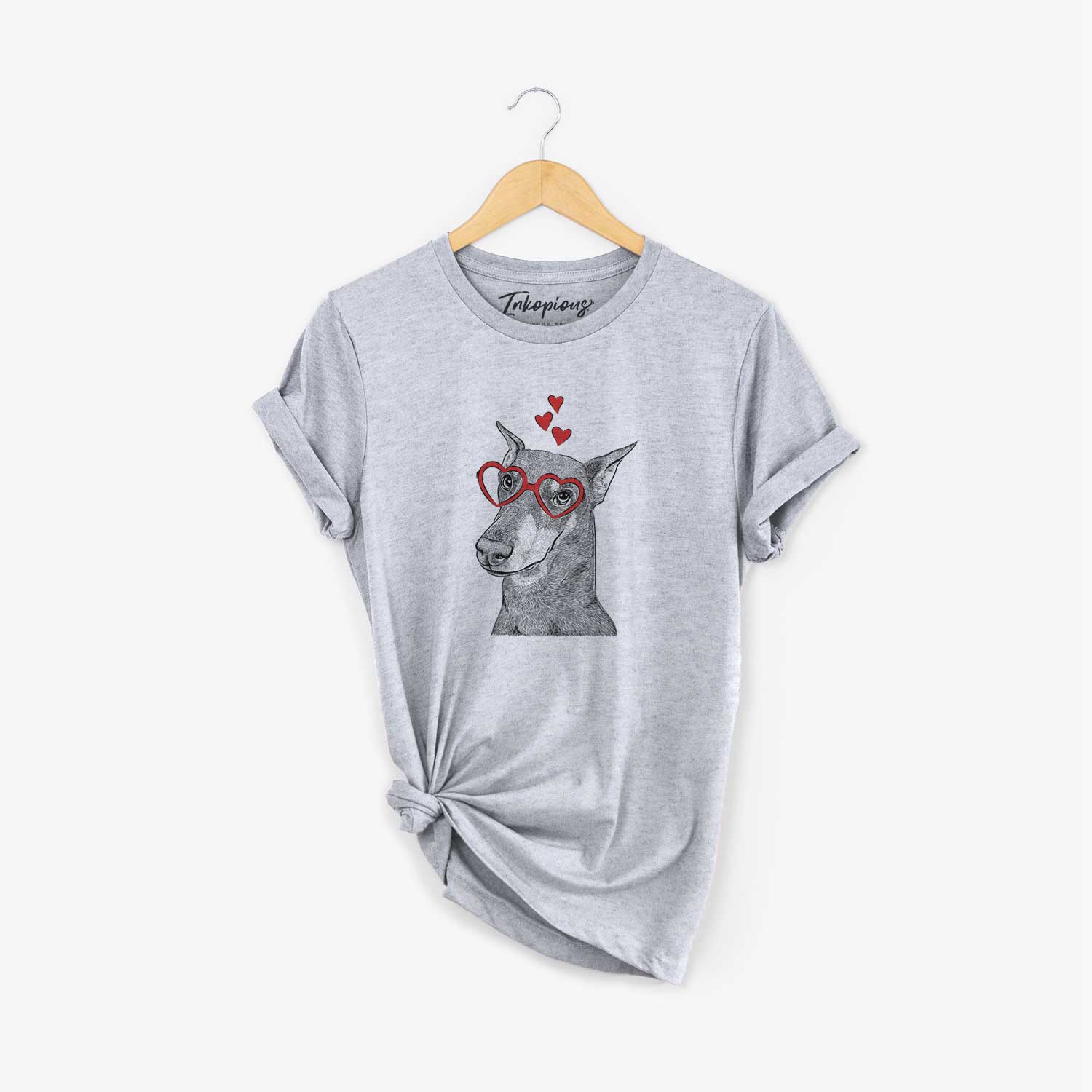 Hand-drawn sketch of Shelby the Doberman Pinscher wearing heart-shaped glasses on a Grey Unisex crewneck