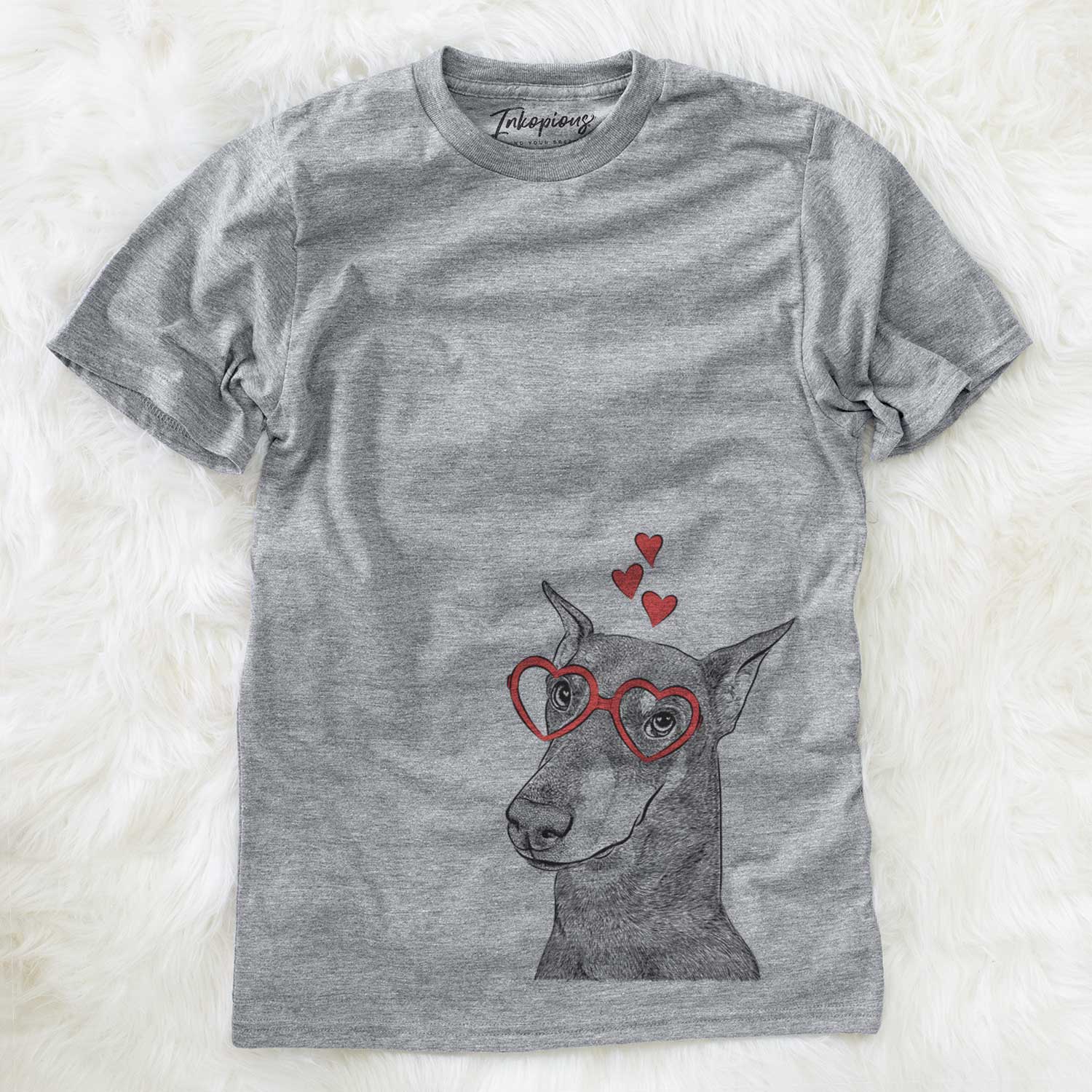Hand-drawn sketch of Shelby the Doberman Pinscher wearing heart-shaped glasses on a Grey Unisex crewneck