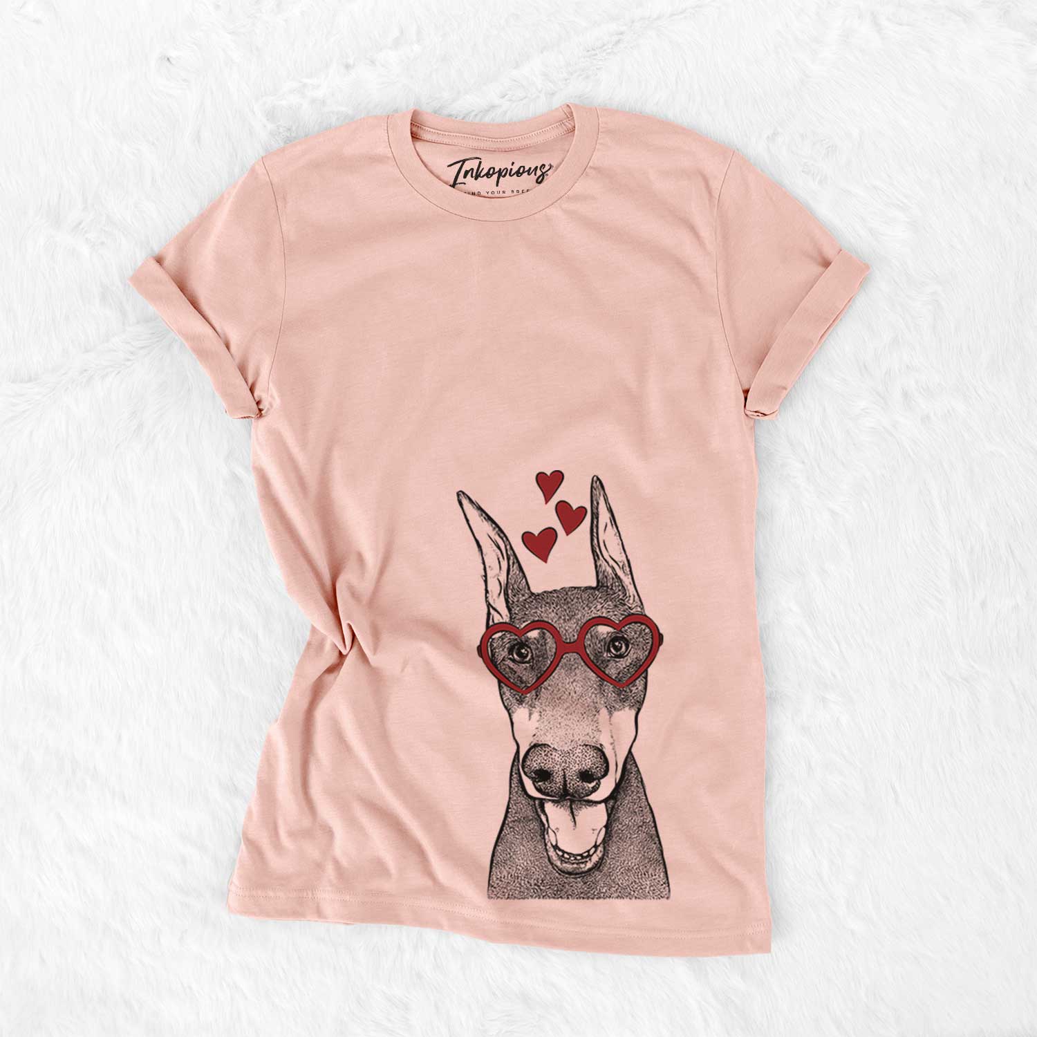 Hand-drawn sketch of Sir Duke the Doberman Pinscher wearing heart-shaped glasses on a Peach Bella Canvas Unisex Crewneck