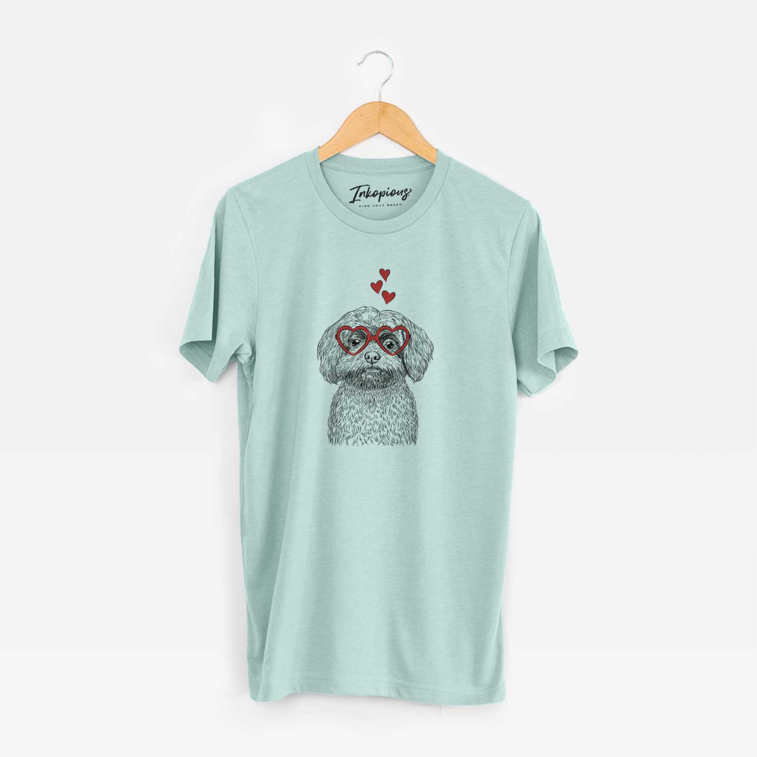Hand-drawn sketch of Stella the Shih Tzu Mix wearing heart-shaped glasses on a Heather Sage Unisex crewneck