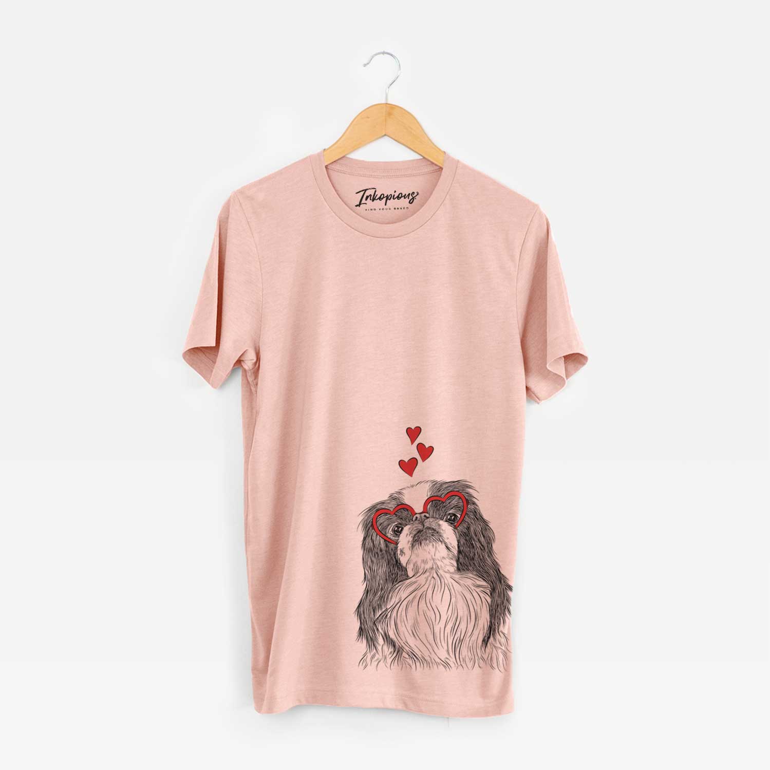 Hand-drawn sketch of Suki the Japanese Chin wearing heart-shaped glasses on a Peach Unisex crewneck