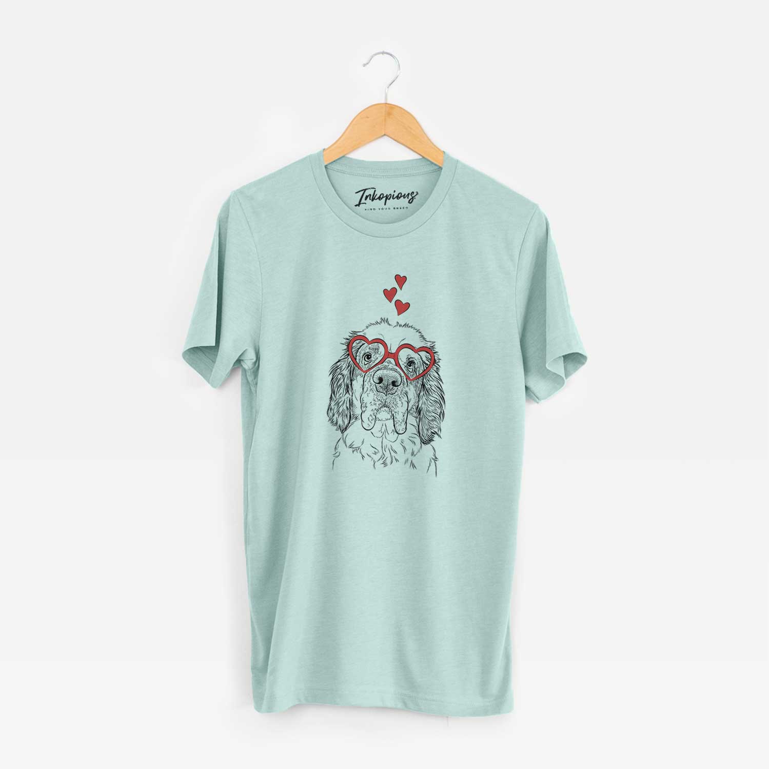 Hand-drawn sketch of Sully the Clumber Spaniel wearing heart-shaped glasses on a Heather Sage Unisex crewneck