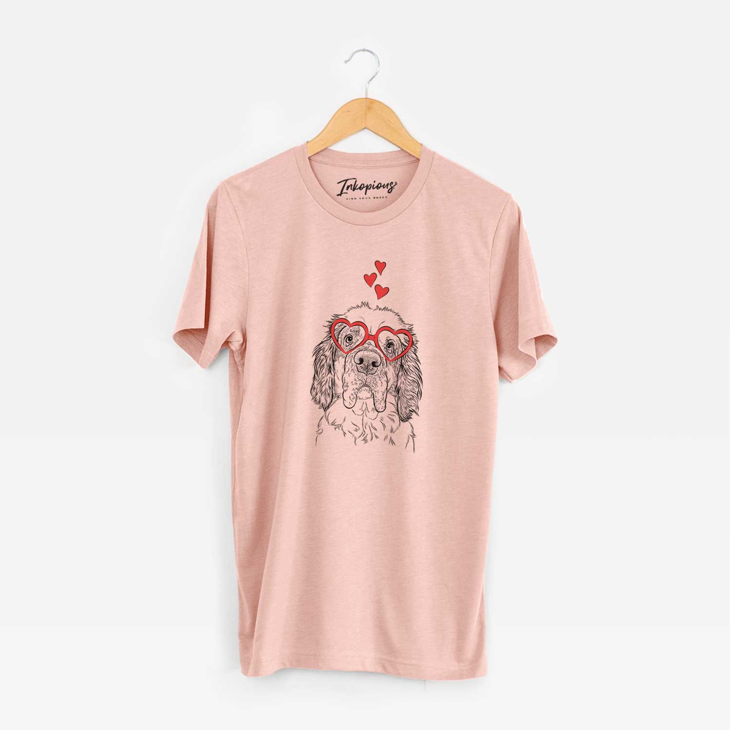Hand-drawn sketch of Sully the Clumber Spaniel wearing heart-shaped glasses on a Peach Unisex crewneck
