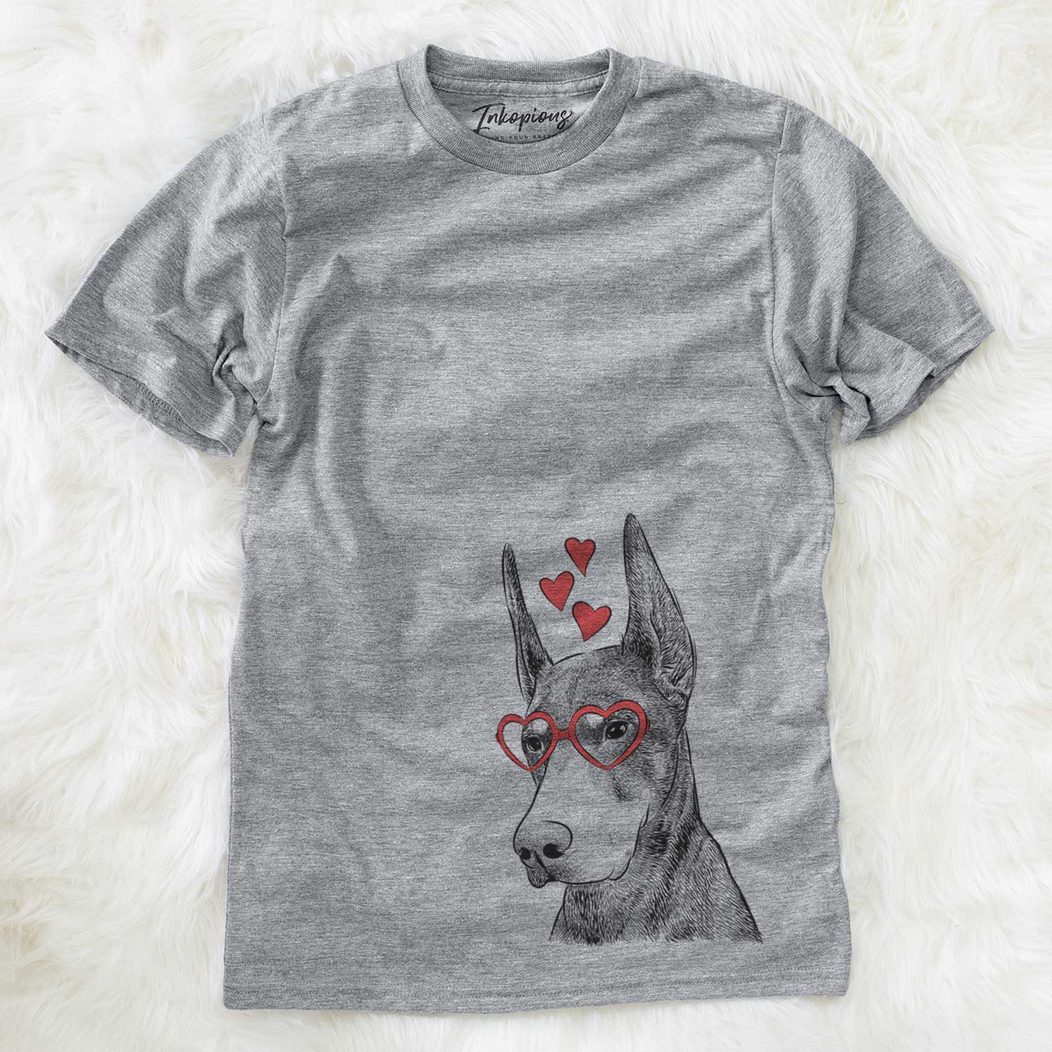 Hand-drawn sketch of Sunny the Doberman Pinscher wearing heart-shaped glasses on a Grey Unisex crewneck
