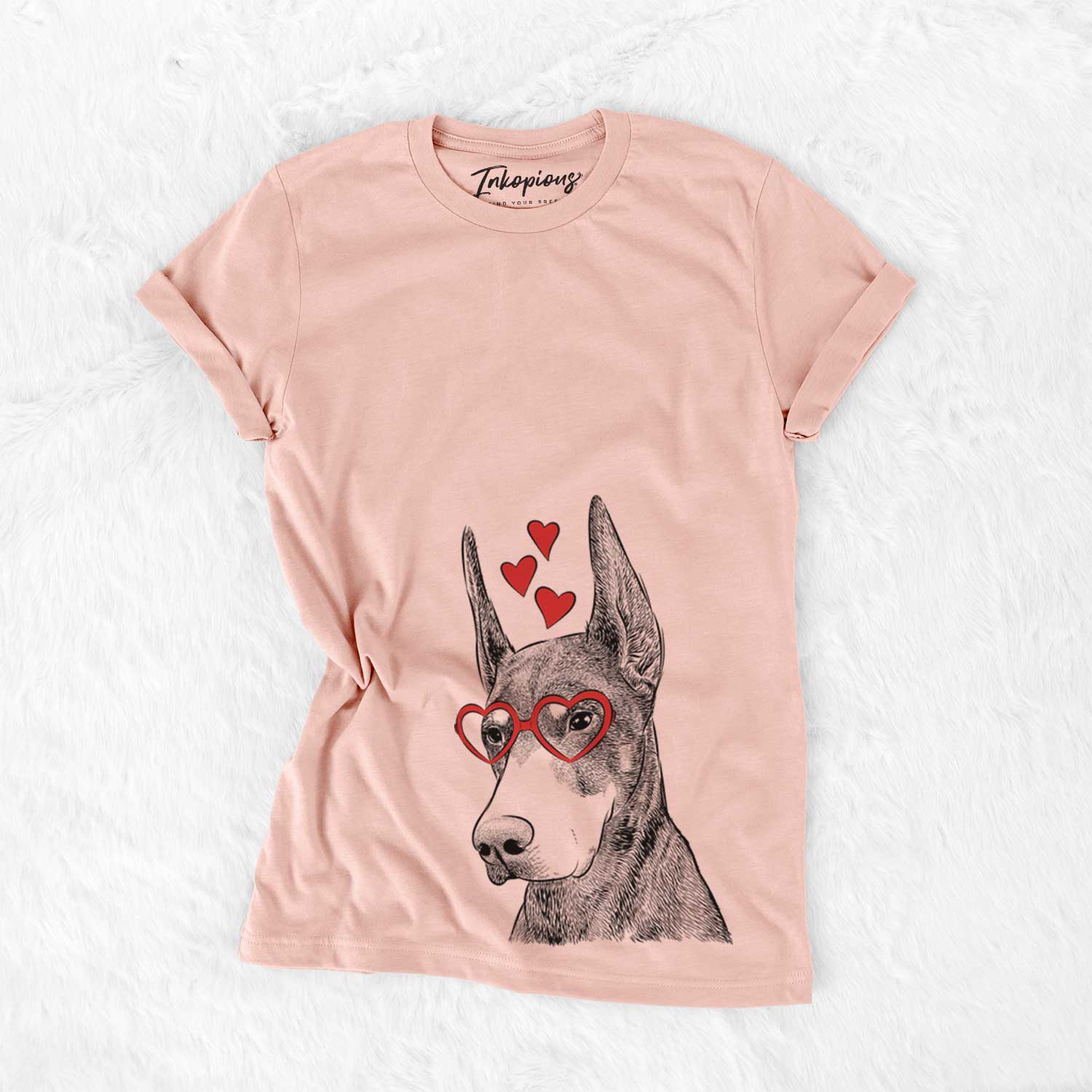 Hand-drawn sketch of Sunny the Doberman Pinscher wearing heart-shaped glasses on a Peach Bella Canvas Unisex Crewneck